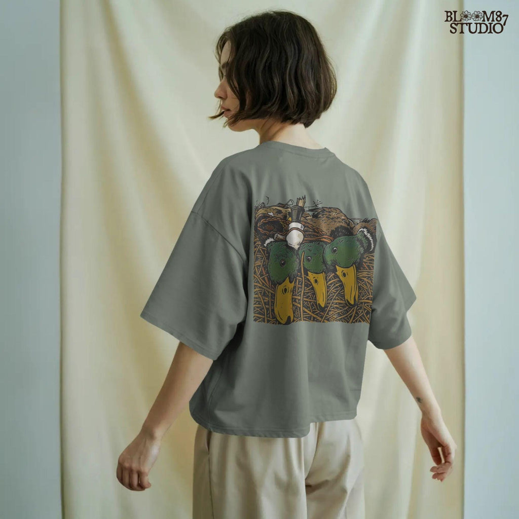 Illustration of three drake mallard ducks with green heads and yellow bills, lying in marsh grass with a duck call, hunting PNG sublimation design