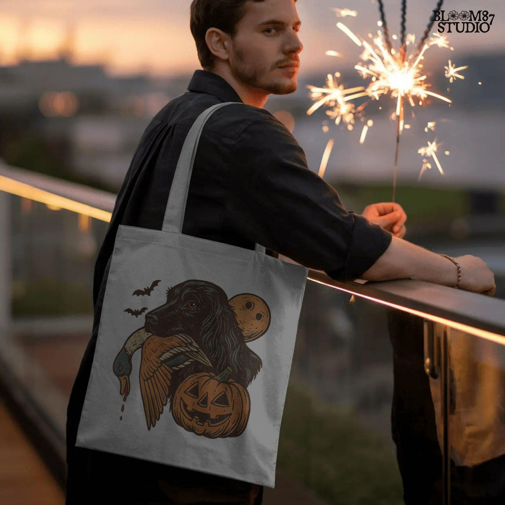 Halloween PNG of a black hunting dog holding a duck with jack-o’-lanterns, bats, and a full moon, rustic sublimation for fall crafts