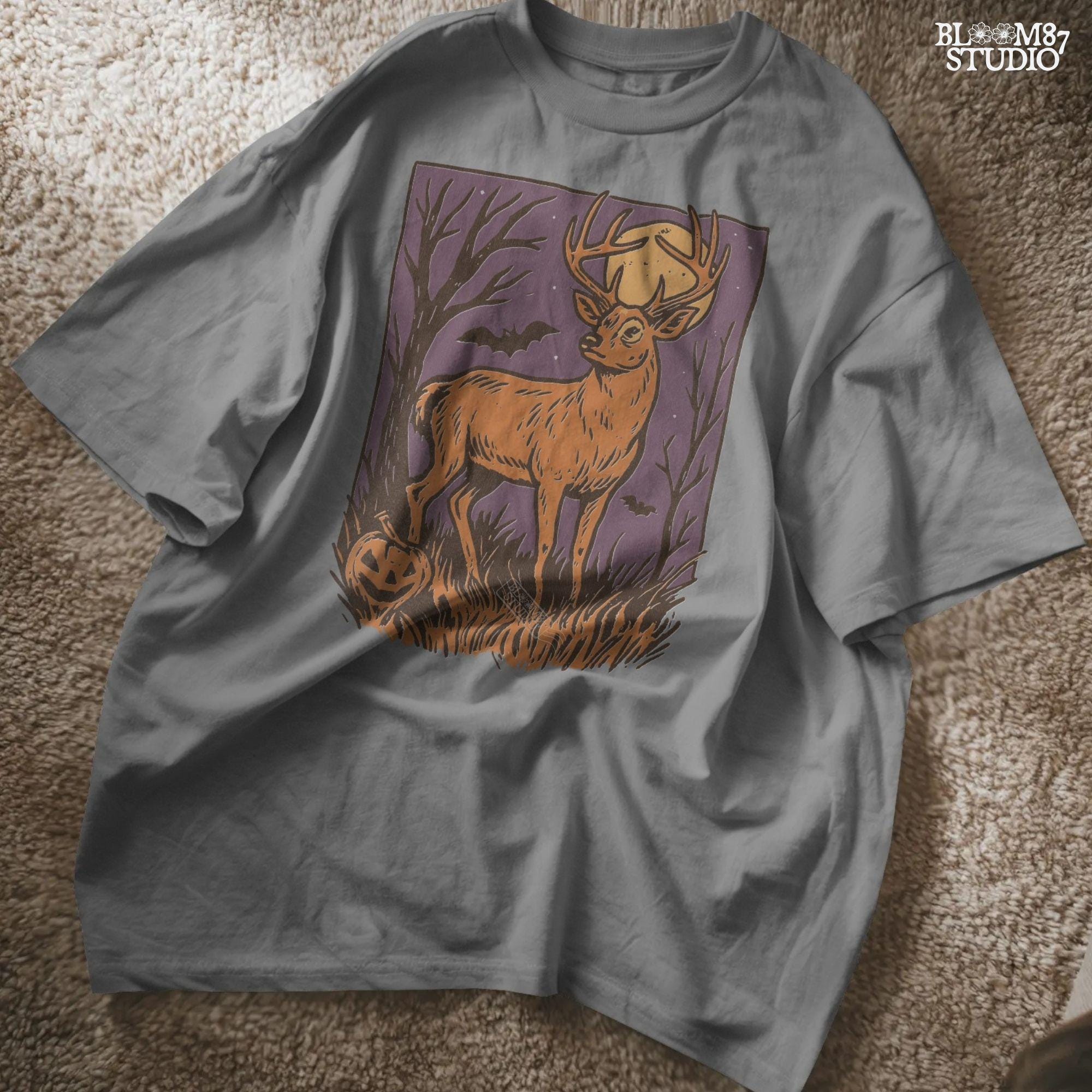 Halloween PNG design of a deer buck under full moon with jack-o’-lantern, bats, and spooky forest background in fall colors