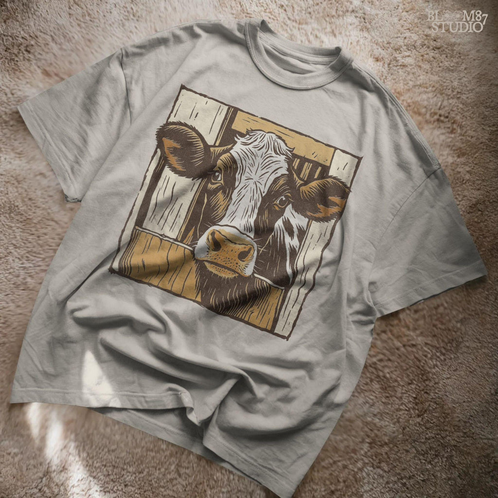 Illustration of a black-and-white dairy cow peeking through a rustic wooden barn door, farmhouse-style sublimation PNG design
