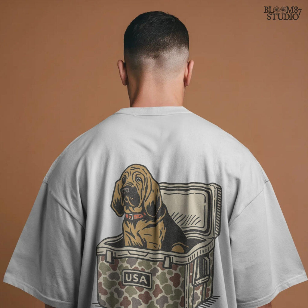 Illustration of a brown bloodhound dog sitting inside a camouflage cooler with “USA” label, hunting and outdoor-themed sublimation PNG design