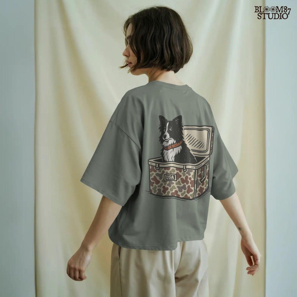 Illustration of a Border Collie sitting inside a camouflage cooler labeled “USA,” rustic farm and ranch-themed sublimation PNG design