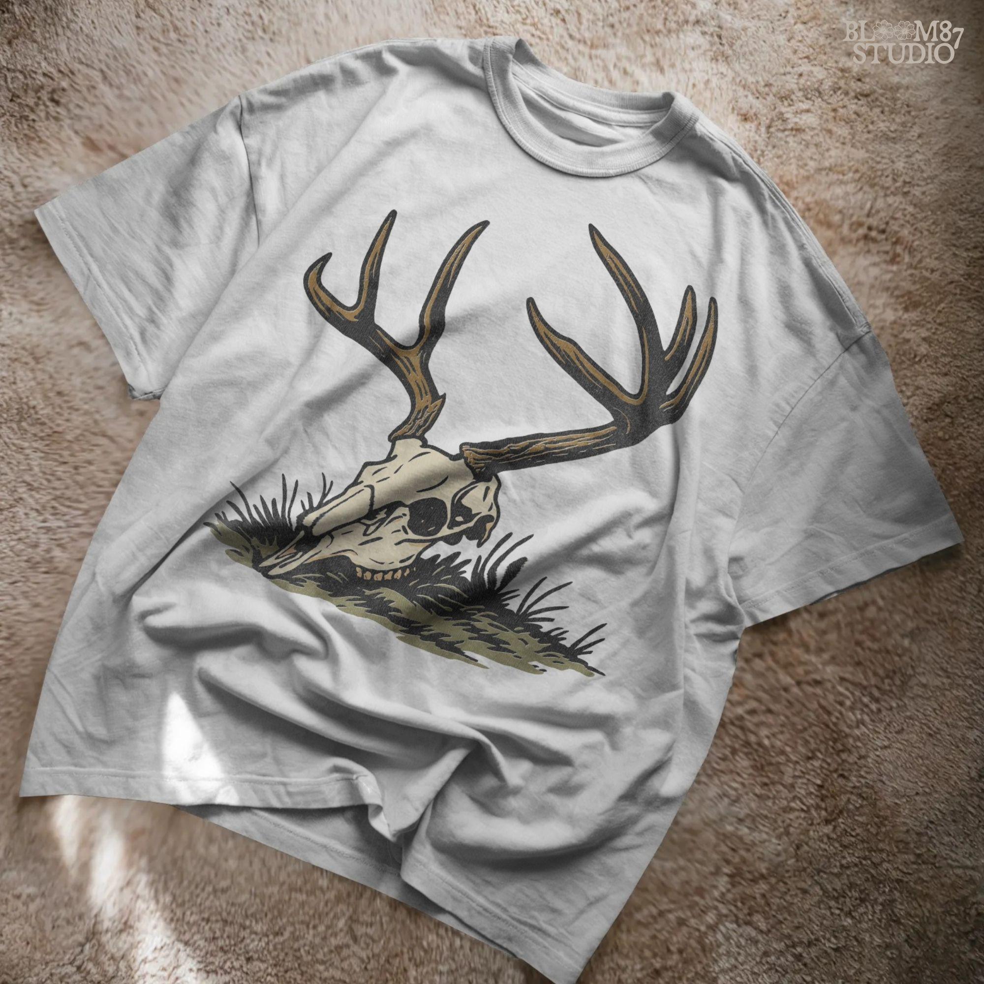 Rustic illustration of a deer skull with large antlers lying on grass, PNG design for hunting-themed and western-style sublimation crafts