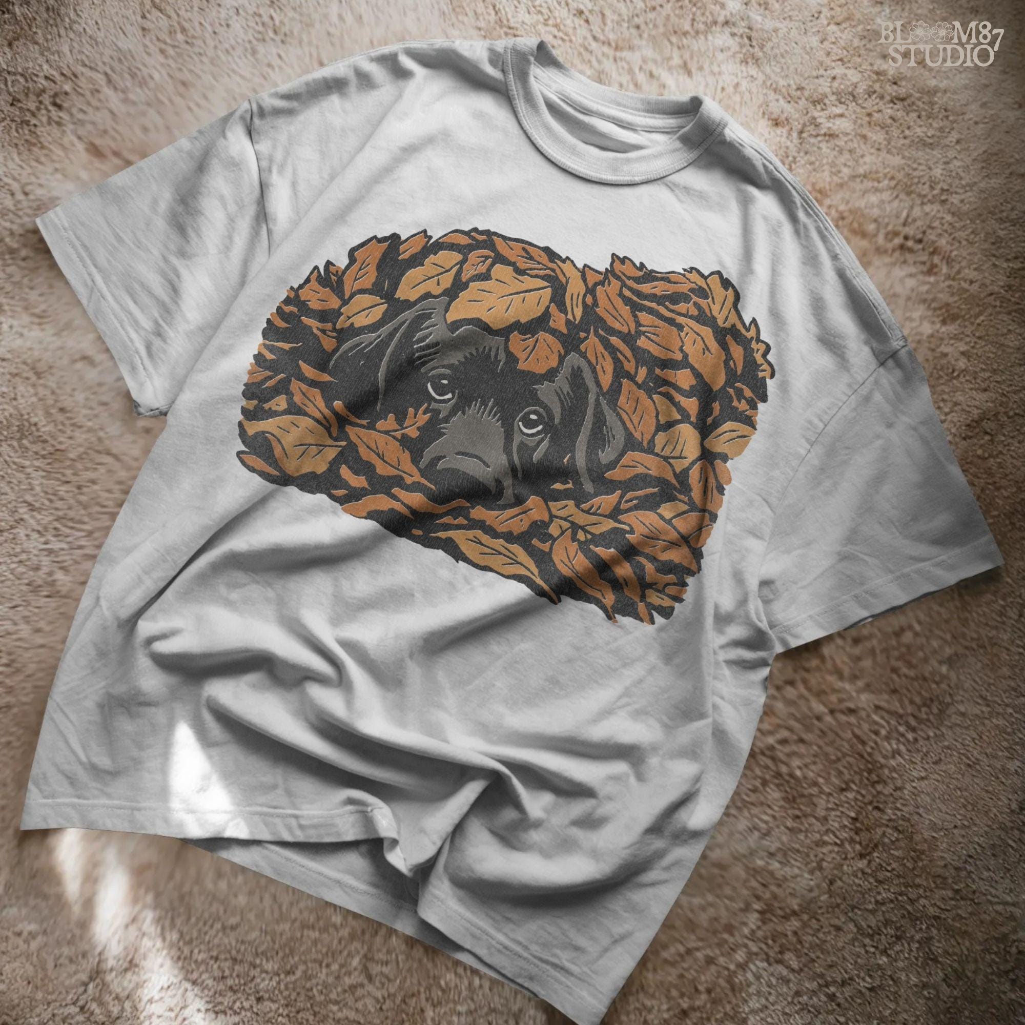 Cute black Labrador retriever peeking through a pile of orange autumn leaves, rustic fall sublimation PNG design