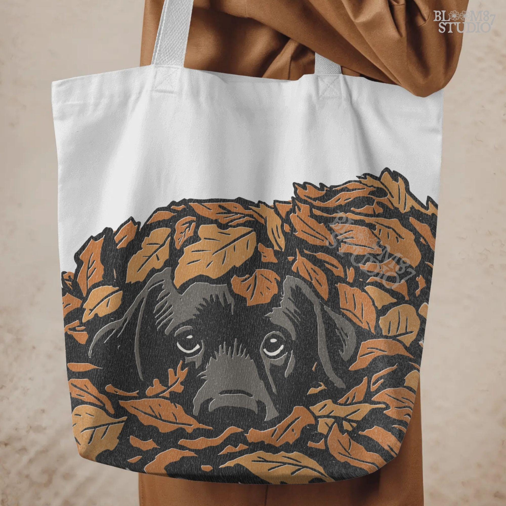 Cute black Labrador retriever peeking through a pile of orange autumn leaves, rustic fall sublimation PNG design