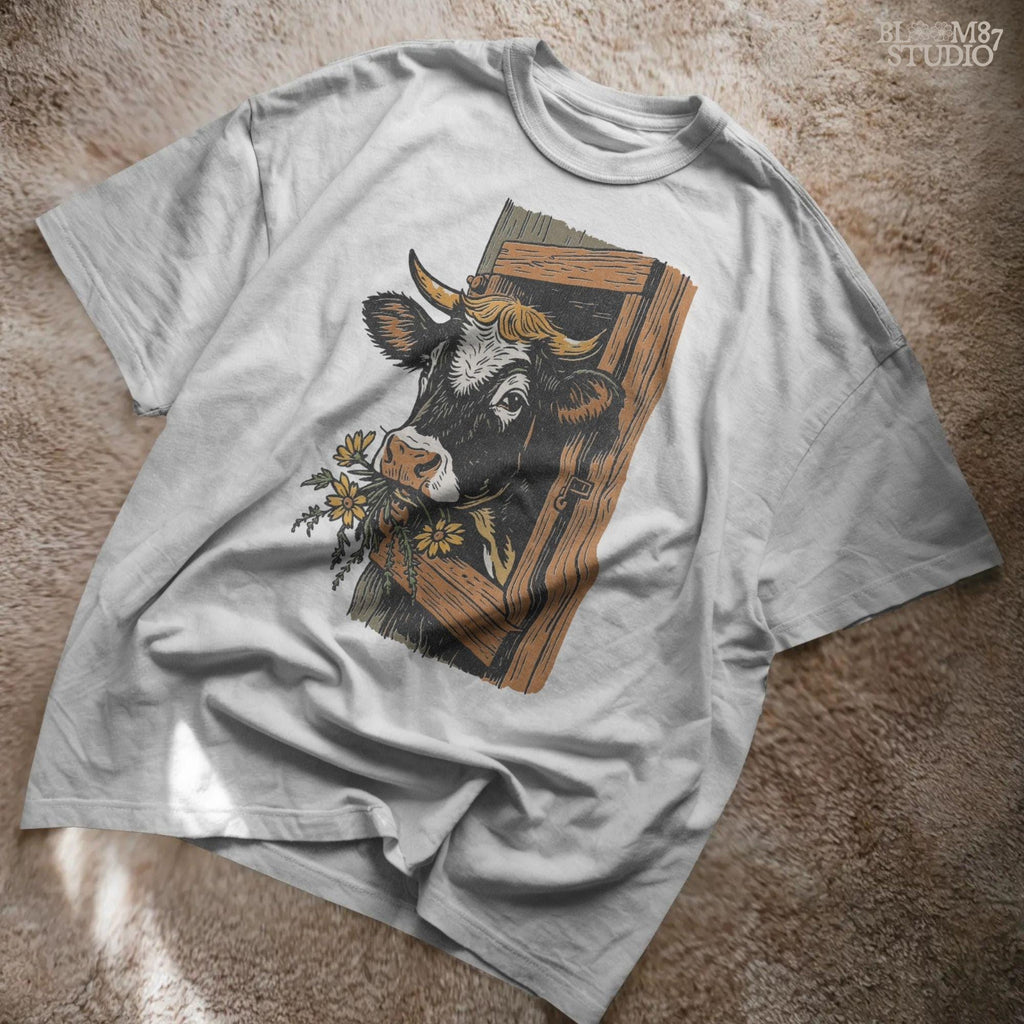 Rustic black and white cow peeking through a wooden barn window, holding yellow wildflowers in its mouth, farm sublimation PNG design