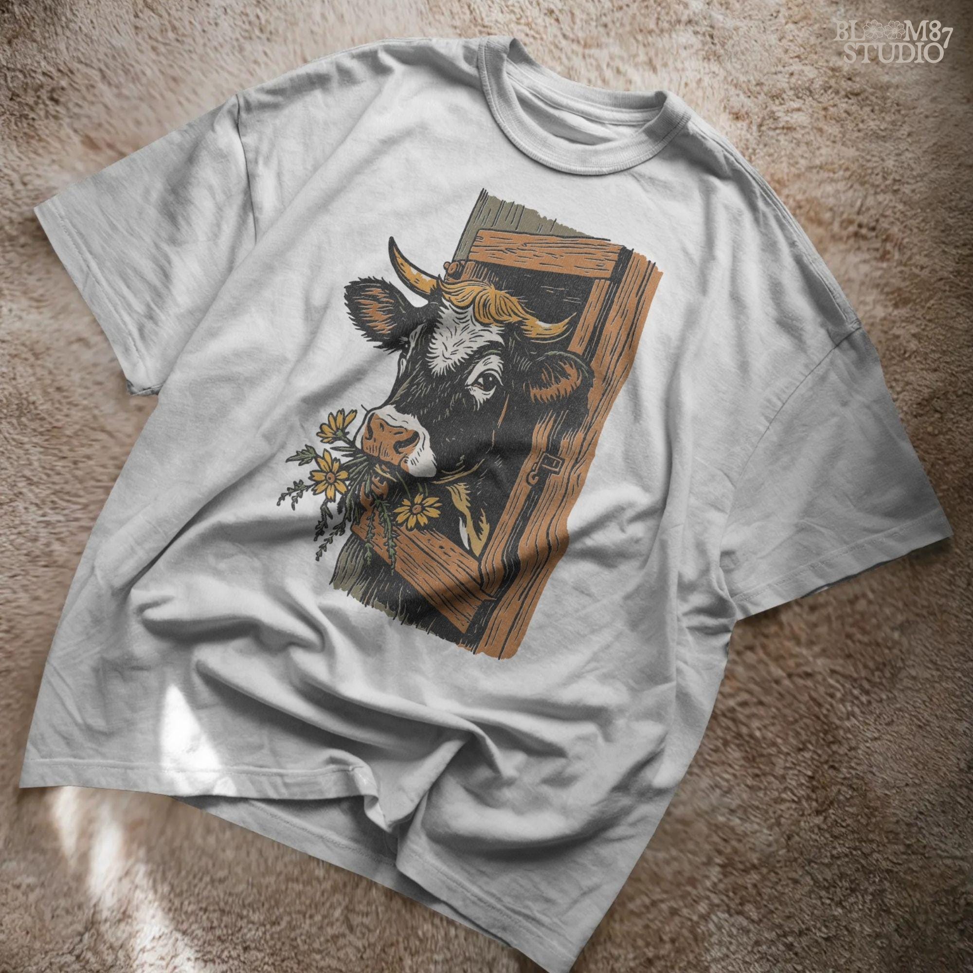 Rustic black and white cow peeking through a wooden barn window, holding yellow wildflowers in its mouth, farm sublimation PNG design