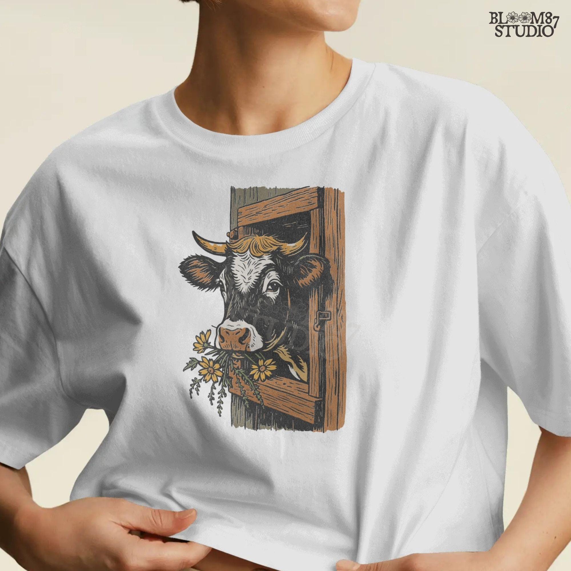 Rustic black and white cow peeking through a wooden barn window, holding yellow wildflowers in its mouth, farm sublimation PNG design