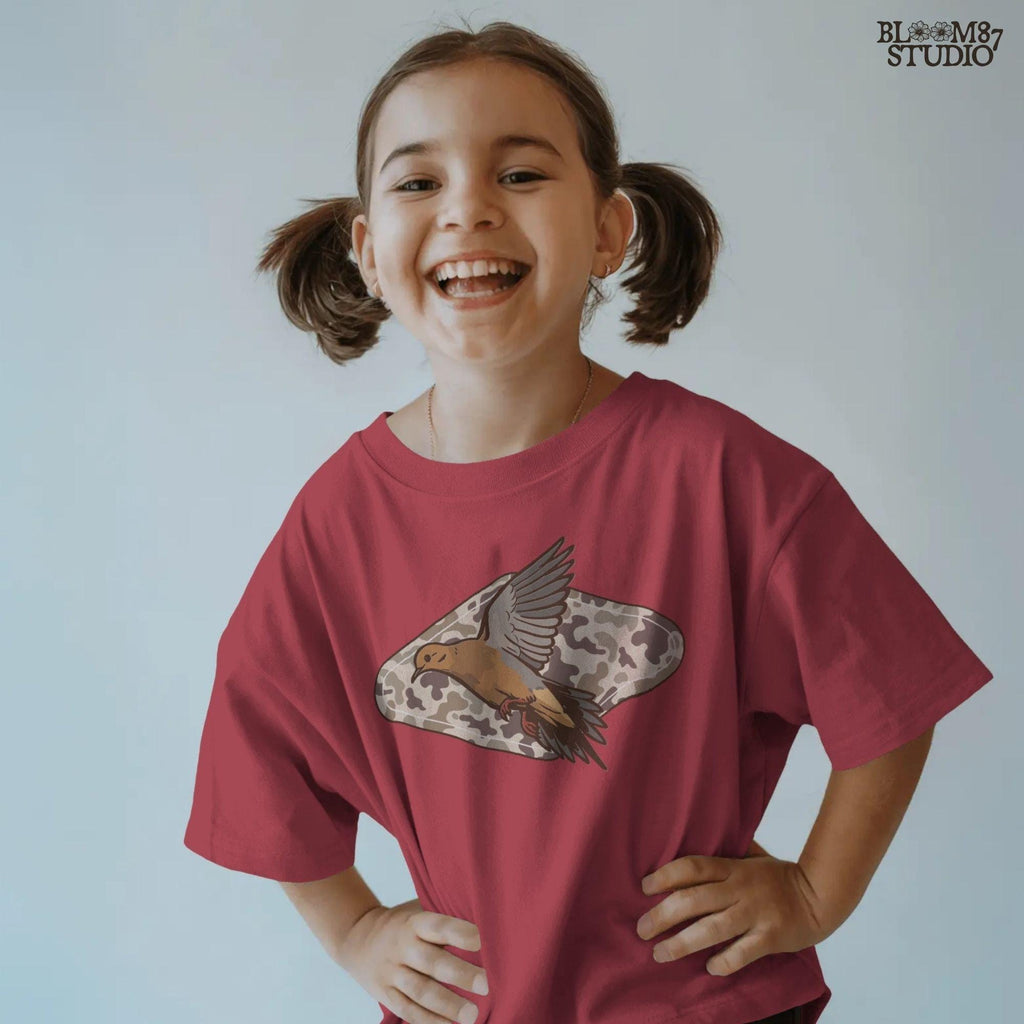 Illustration of a flying mourning dove over a tan and brown camo-patterned background, designed for hunting-themed sublimation prints.