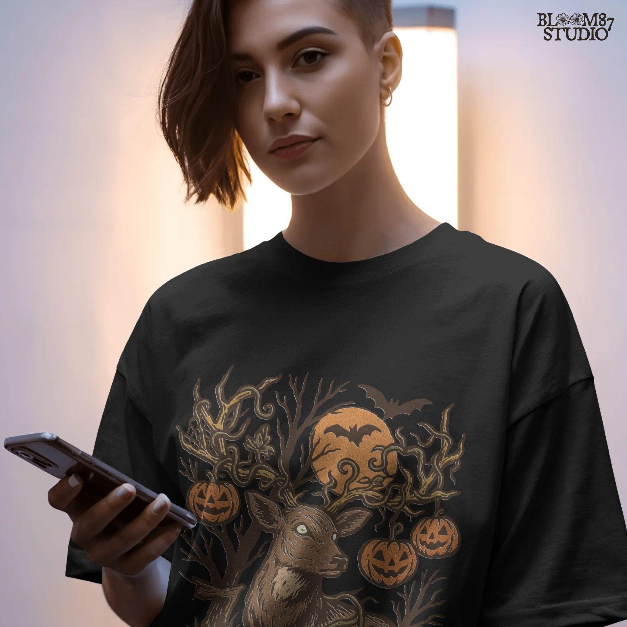 Halloween-themed sublimation PNG of a deer with spiderweb antlers, jack-o’-lantern pumpkins, bats, and a spooky forest background.v