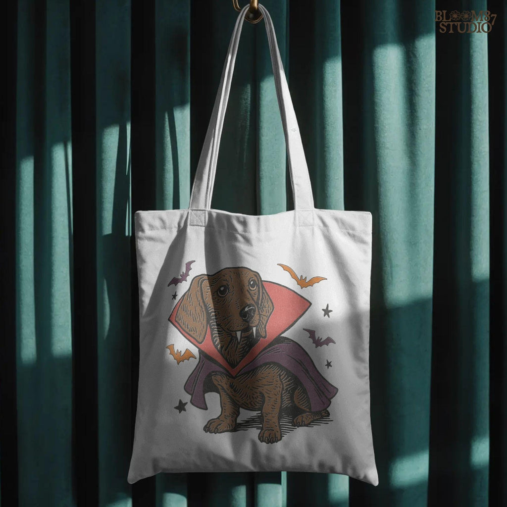 Cute dachshund dressed as a Halloween vampire with red and purple cape, fangs, and surrounded by bats on transparent background.