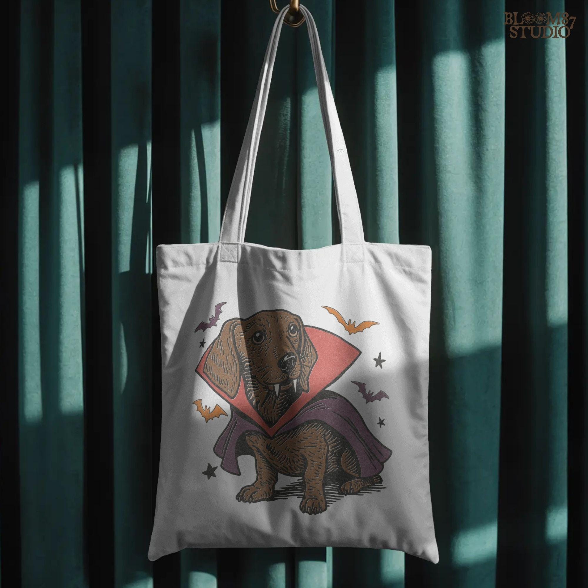 Cute dachshund dressed as a Halloween vampire with red and purple cape, fangs, and surrounded by bats on transparent background.