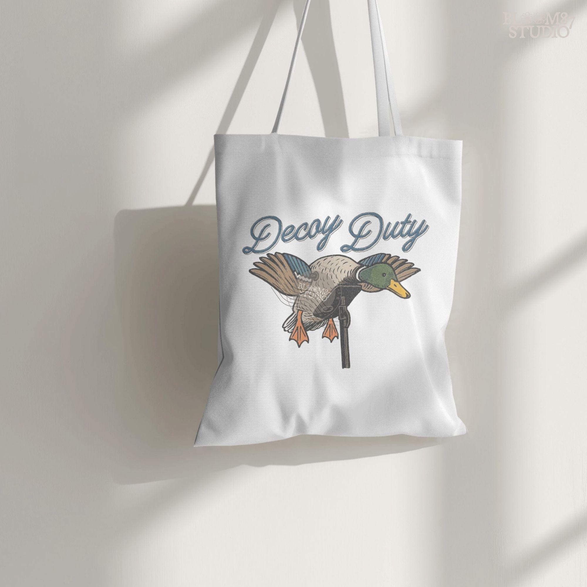 Illustration of a mallard duck hunting decoy with the words “Decoy Duty,” rustic sublimation PNG design for hunters and outdoor artwork.