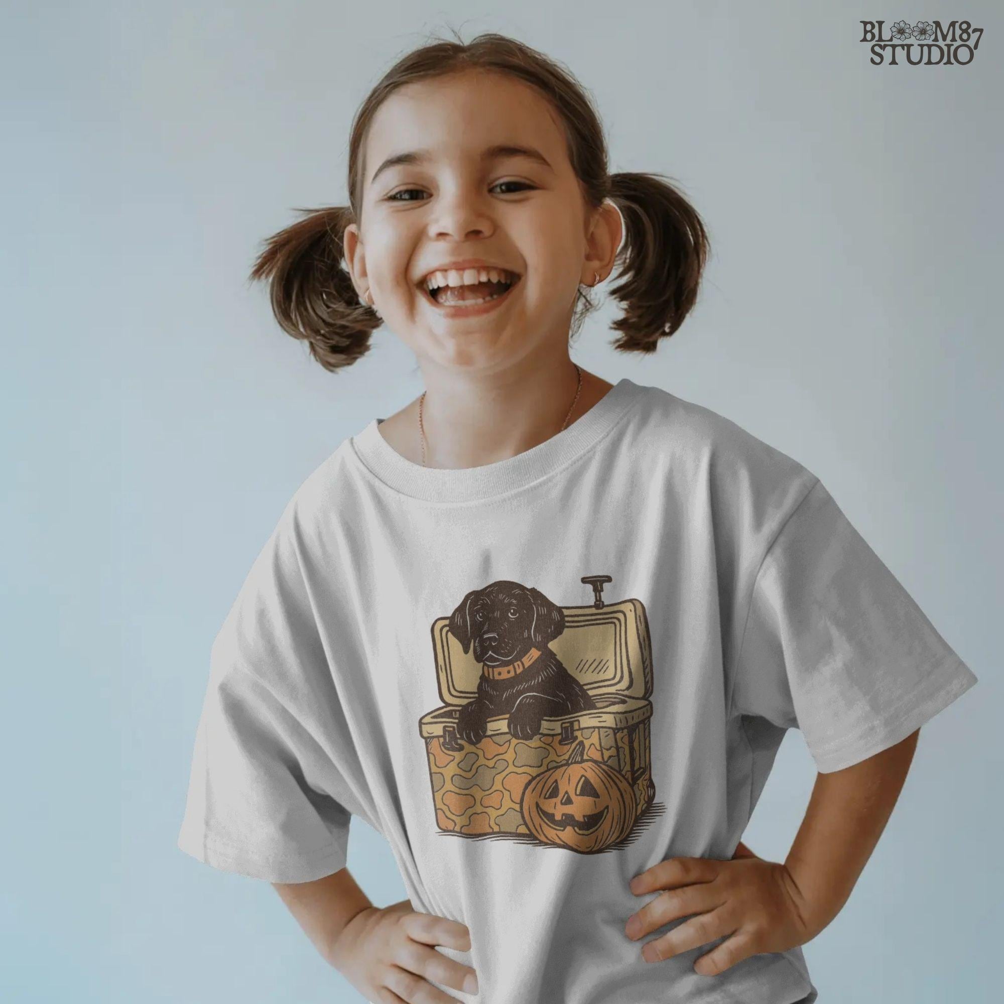 Black Labrador retriever sitting in a cooler with a pumpkin, Halloween sublimation PNG design for dog lovers, seasonal crafts, and apparel.