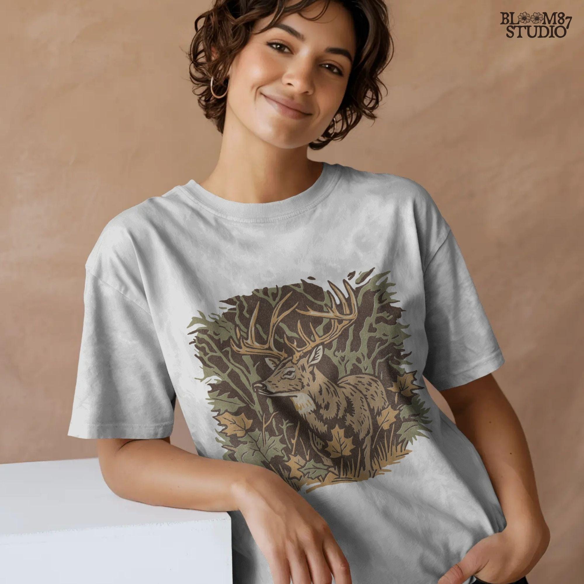 Illustration of a whitetail buck in a fall forest surrounded by autumn leaves, ideal for rustic sublimation or hunting-themed shirt design.