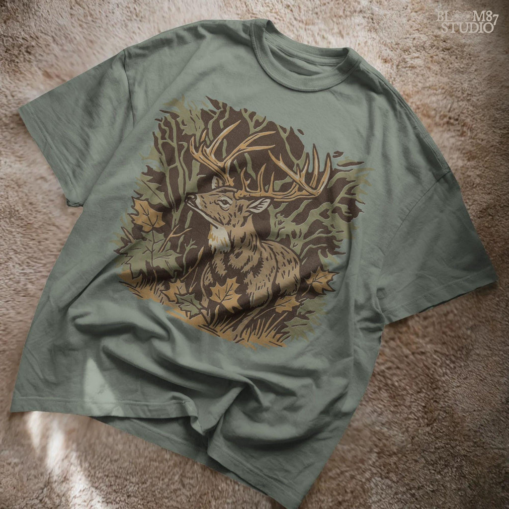 Illustration of a whitetail buck in a fall forest surrounded by autumn leaves, ideal for rustic sublimation or hunting-themed shirt design.
