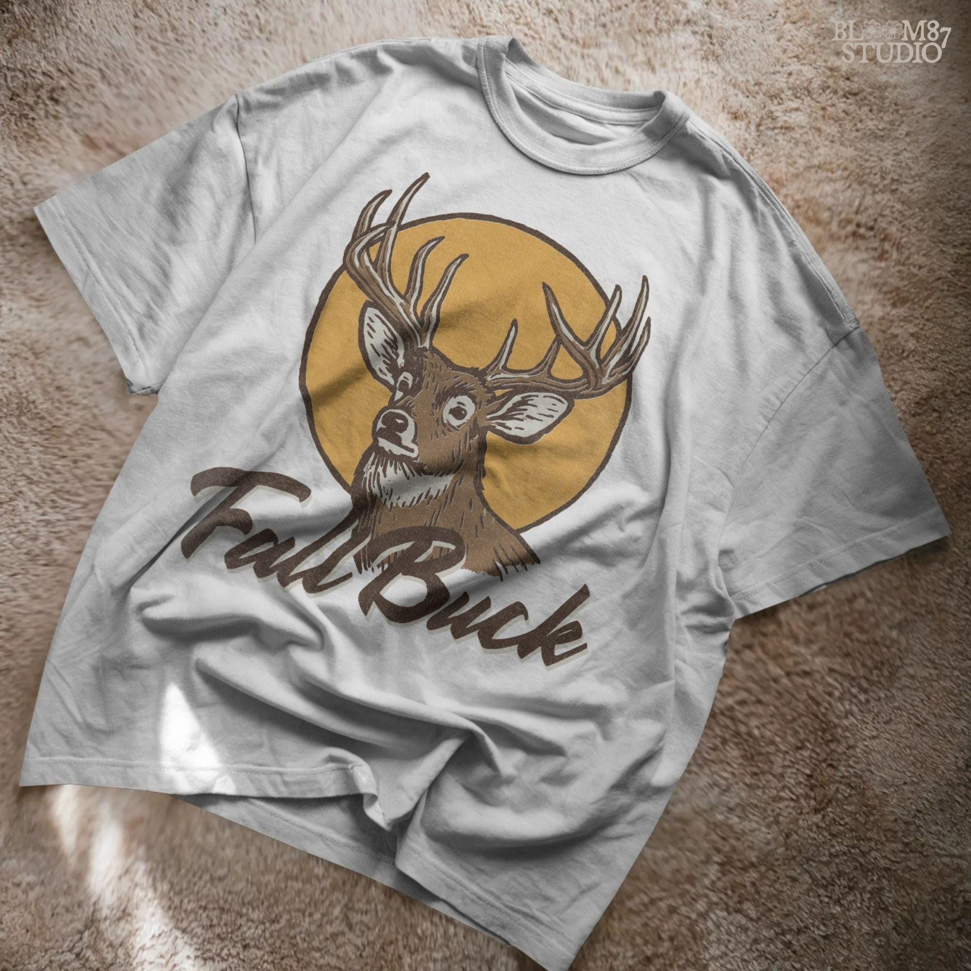 Illustration of a whitetail buck with antlers in front of a fall sun and the text “Fall Buck,” perfect for rustic hunting sublimation designs.