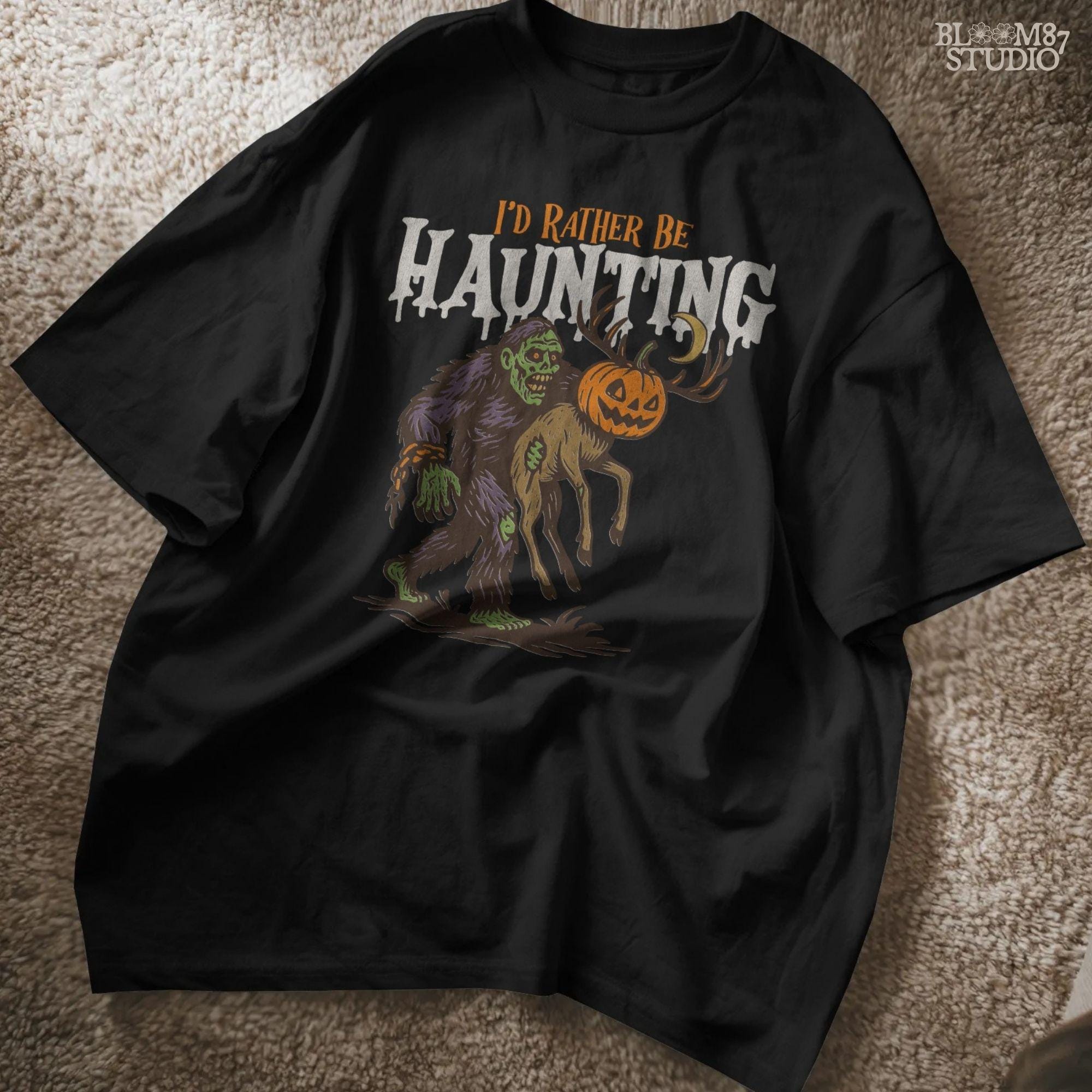 Humorous Halloween sublimation PNG featuring a zombie carrying a deer with a jack-o’-lantern head and the phrase “I’d Rather Be Haunting.”