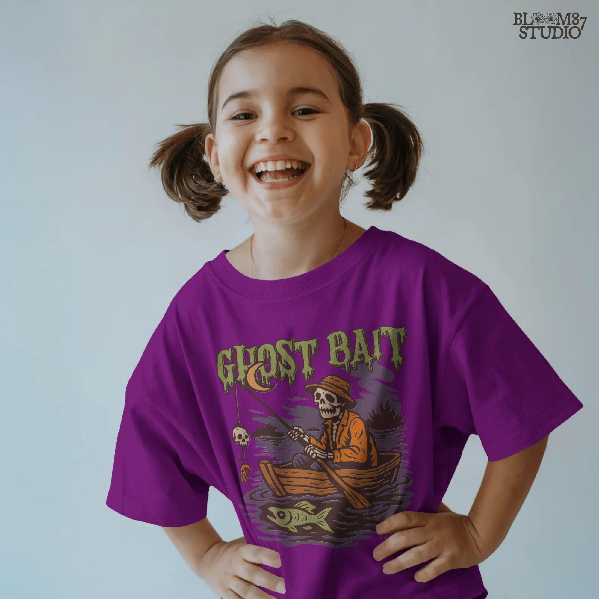 Funny Halloween PNG design of a skeleton fisherman in a wooden boat with a skull as bait and a ghostly fish, titled “Ghost Bait”.