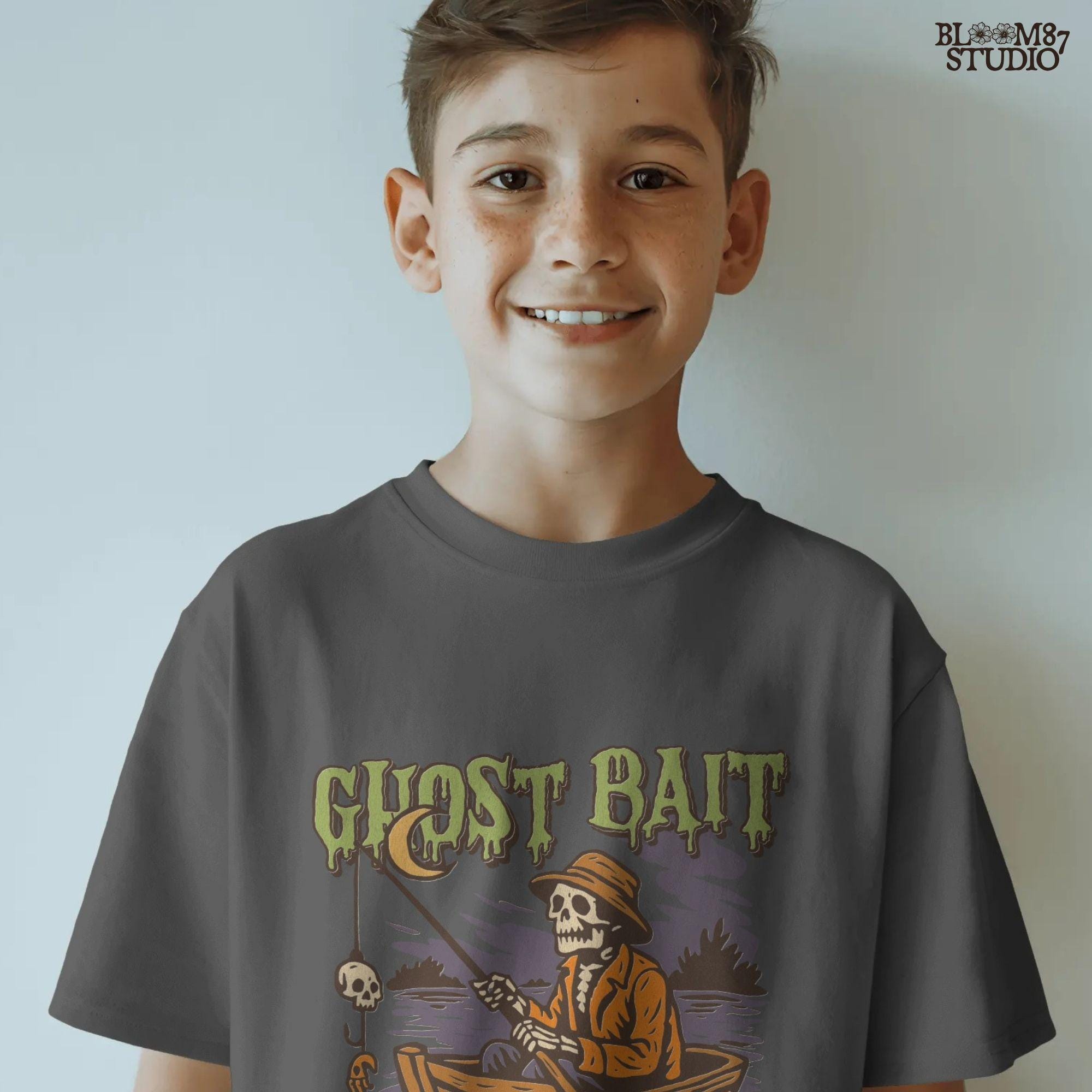 Funny Halloween PNG design of a skeleton fisherman in a wooden boat with a skull as bait and a ghostly fish, titled “Ghost Bait”.