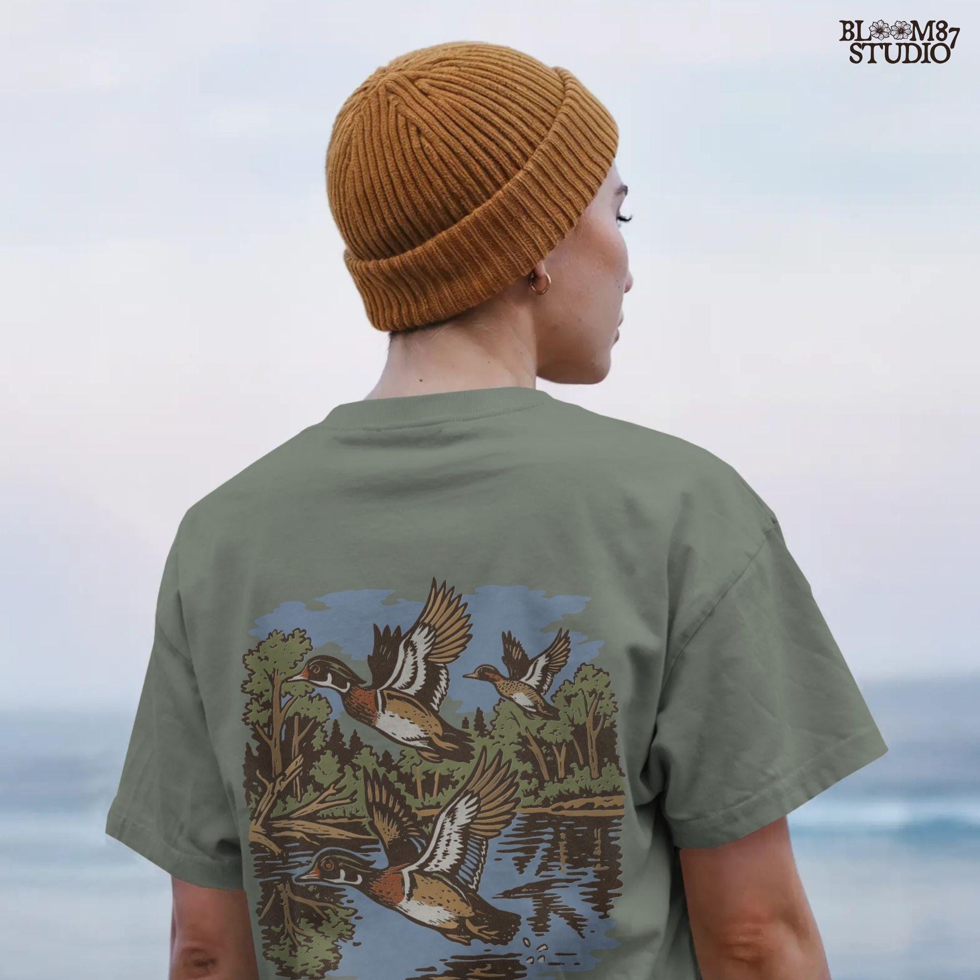 Vintage wood duck artwork showing ducks flying over a calm forest lake, perfect for fall hunting-themed sublimation designs and rustic crafts.