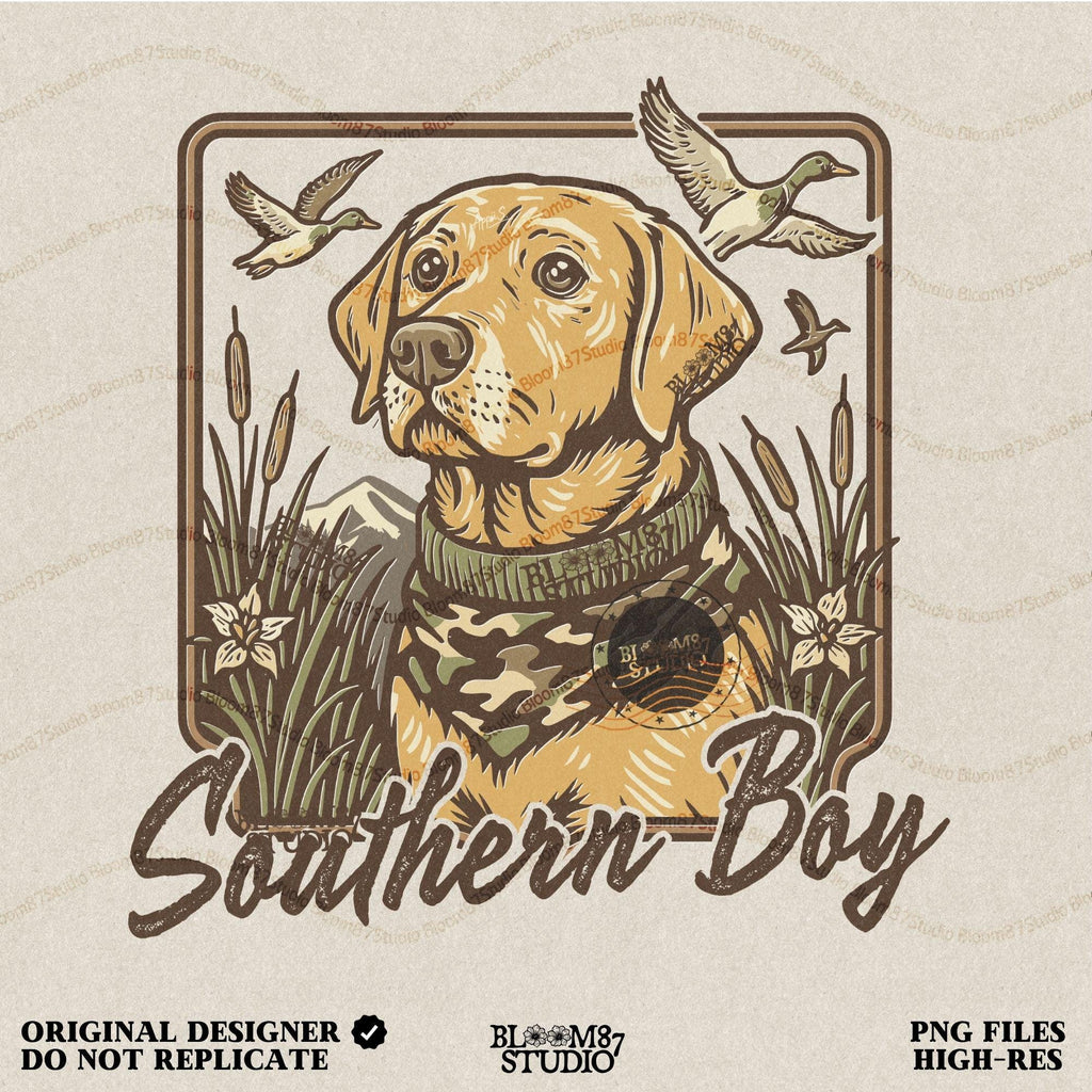 May include: A person wearing a light gray t-shirt with a brown and yellow illustration of a dog wearing a camouflage scarf. The illustration is surrounded by a brown frame and the text 'Southern Boy' is printed below the dog.