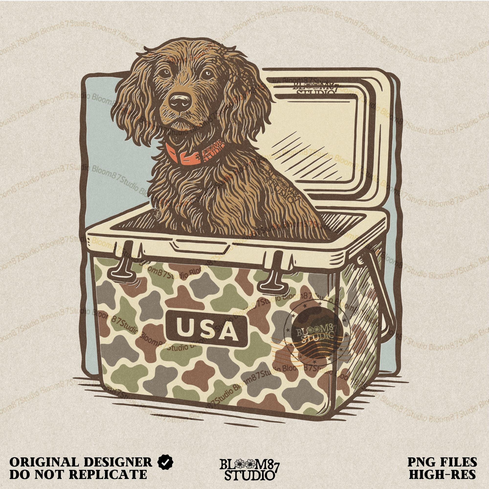 Hunting dog with curly fur sitting inside a camouflage cooler marked “USA” in a retro-style outdoors graphic.