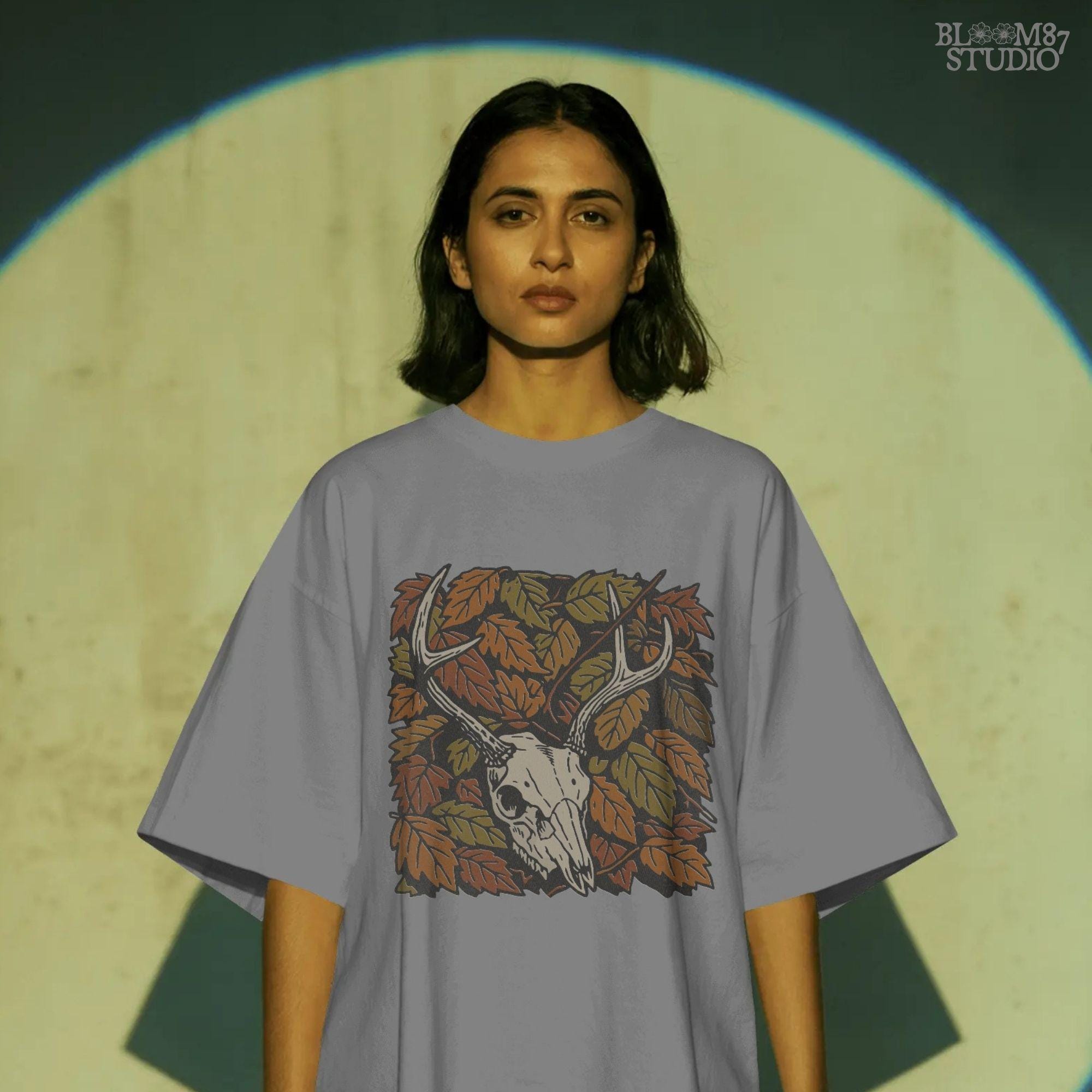 Deer skull with antlers surrounded by autumn leaves, rustic fall hunting sublimation PNG design.