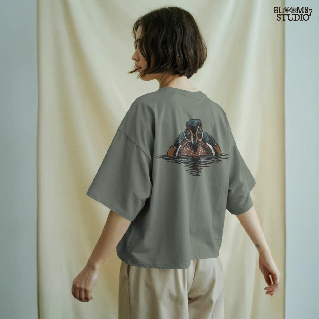 Illustration of a drake wood duck with chestnut, teal, and white plumage swimming on calm water, hunting-themed PNG sublimation design