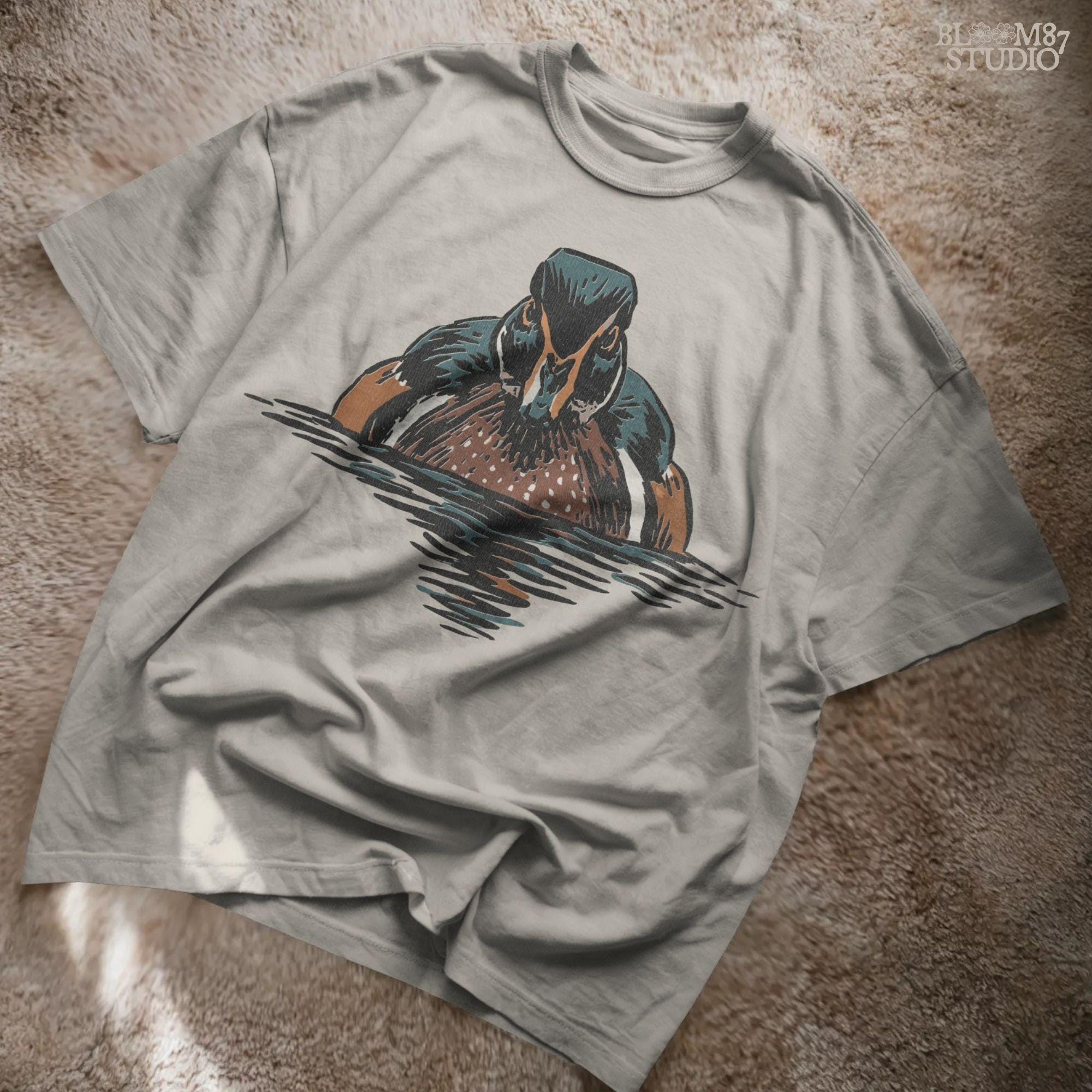 Illustration of a drake wood duck with chestnut, teal, and white plumage swimming on calm water, hunting-themed PNG sublimation design