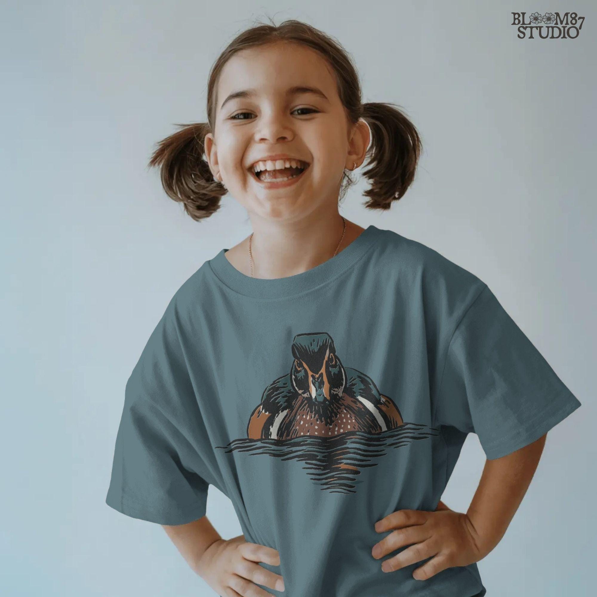 Illustration of a drake wood duck with chestnut, teal, and white plumage swimming on calm water, hunting-themed PNG sublimation design