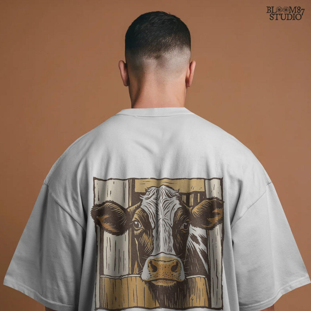 Illustration of a black-and-white dairy cow peeking through a rustic wooden barn door, farmhouse-style sublimation PNG design