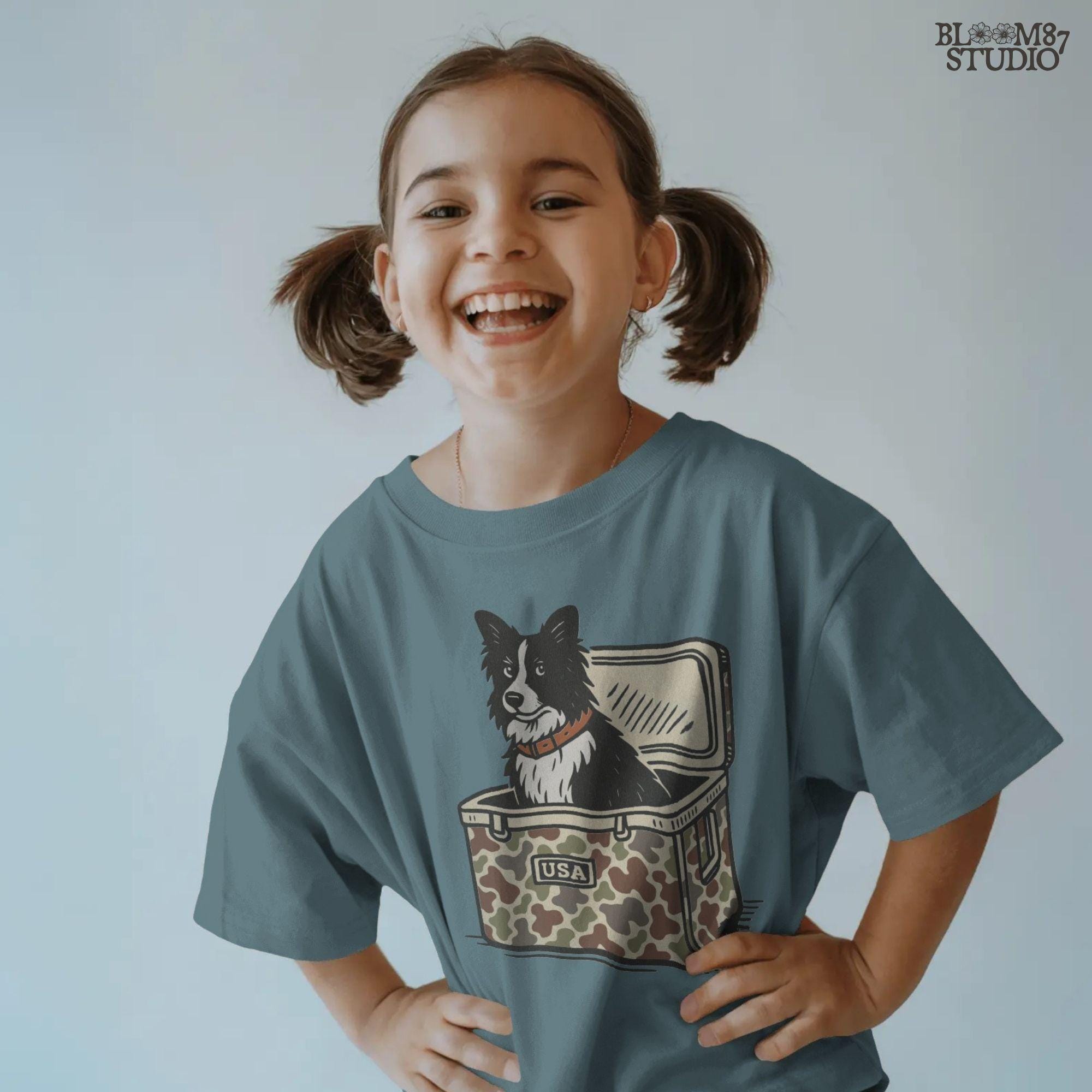 Illustration of a Border Collie sitting inside a camouflage cooler labeled “USA,” rustic farm and ranch-themed sublimation PNG design