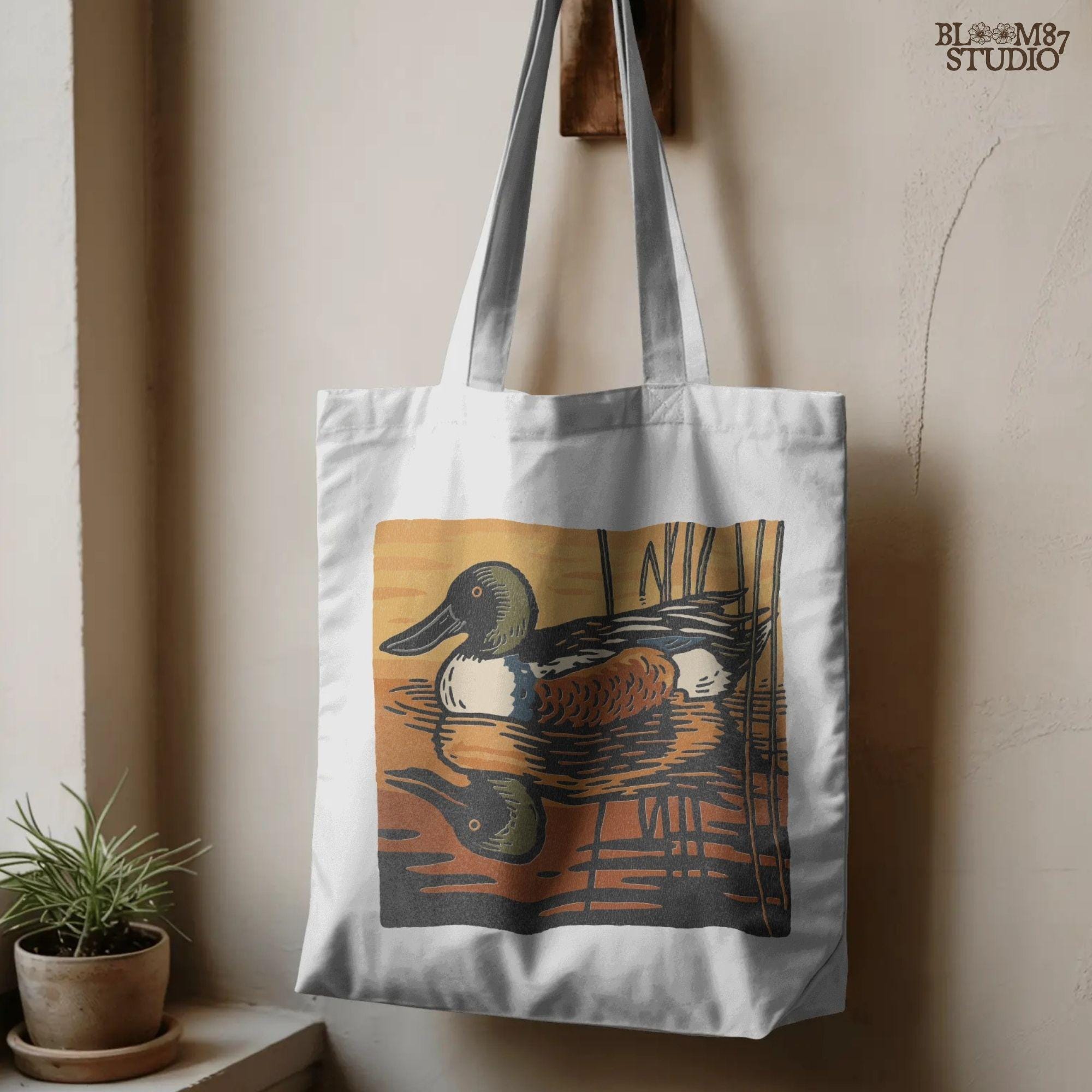 Illustration of a Northern Shoveler duck swimming in a marsh pond at sunset with warm orange and brown reflections, digital PNG for sublimation crafts