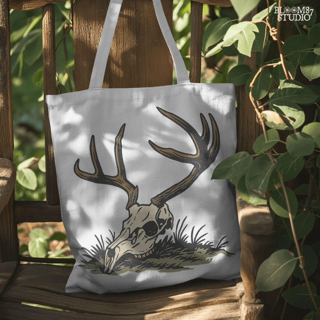 Rustic illustration of a deer skull with large antlers lying on grass, PNG design for hunting-themed and western-style sublimation crafts