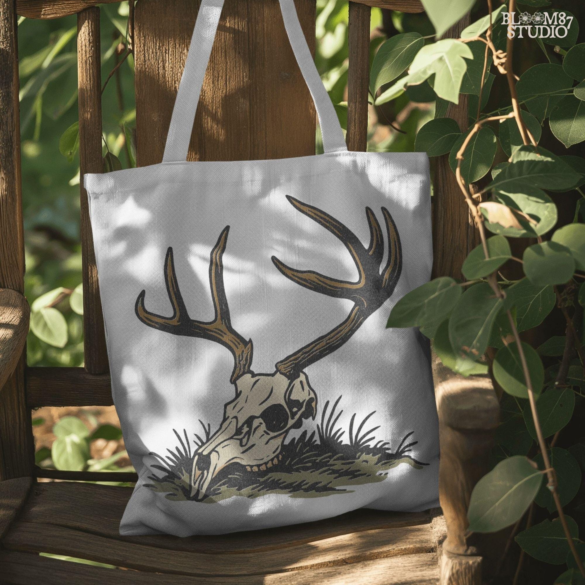 Rustic illustration of a deer skull with large antlers lying on grass, PNG design for hunting-themed and western-style sublimation crafts