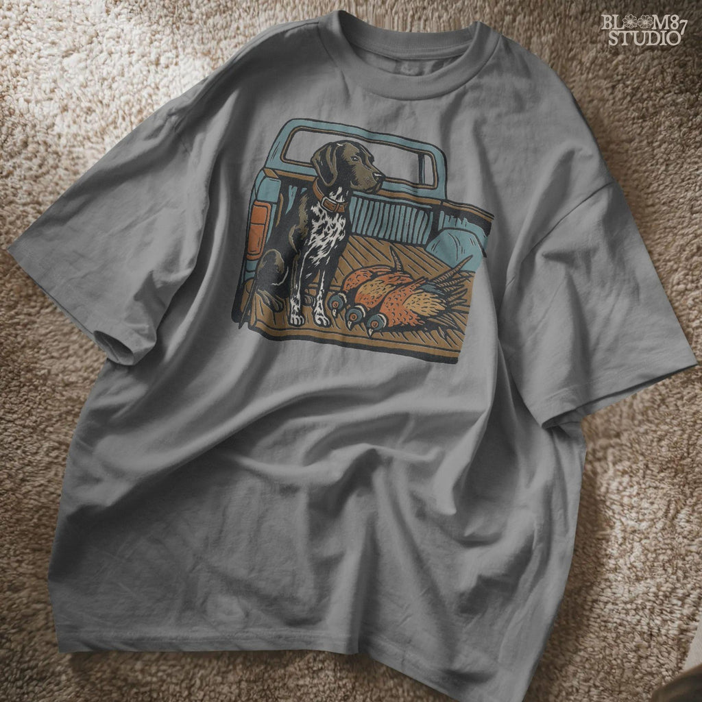 Illustration of a German Shorthaired Pointer hunting dog sitting in a pickup truck with three pheasants, sublimation PNG design.