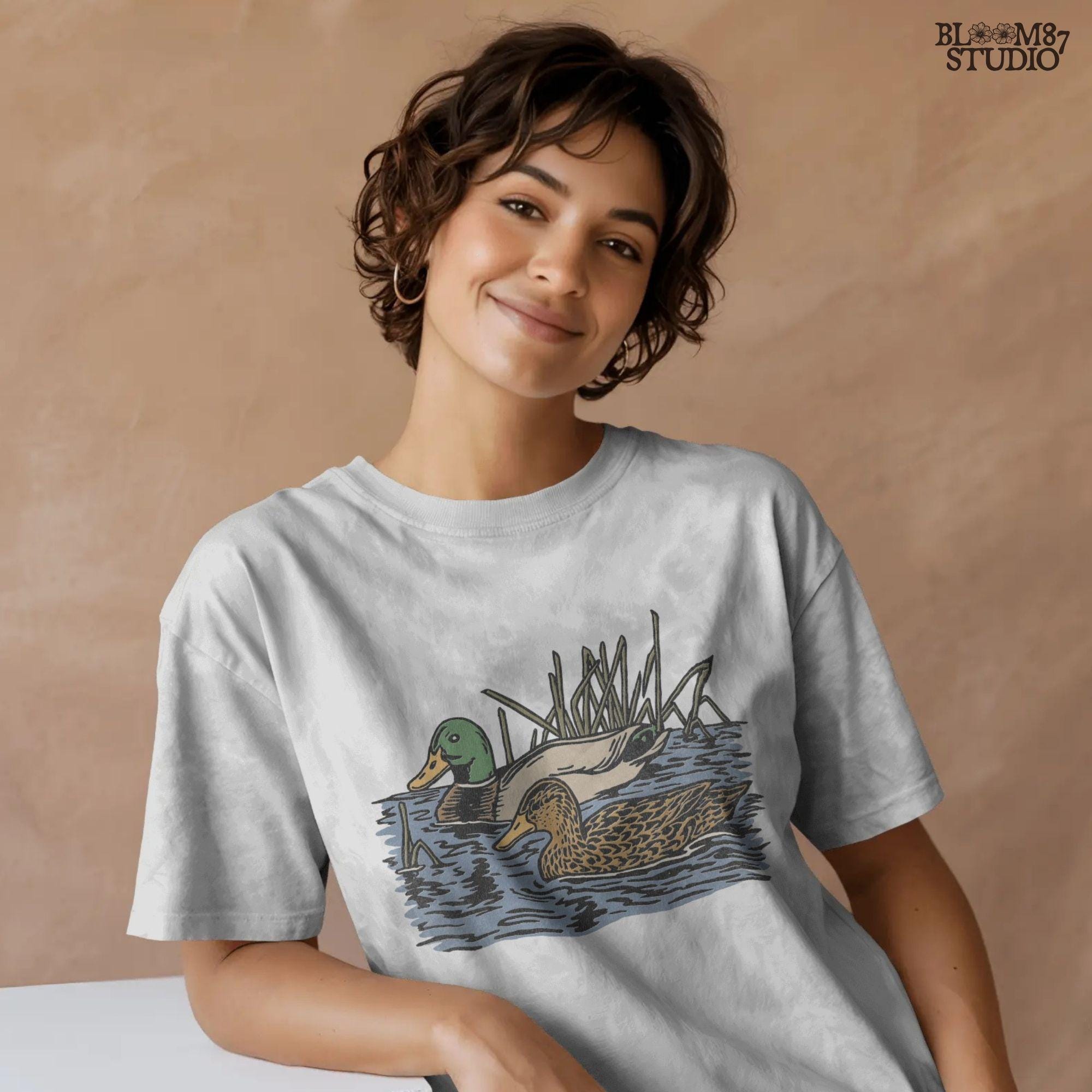 Illustration of a male and female mallard duck swimming in marsh water among reeds, ideal for waterfowl hunting and lodge décor sublimation designs