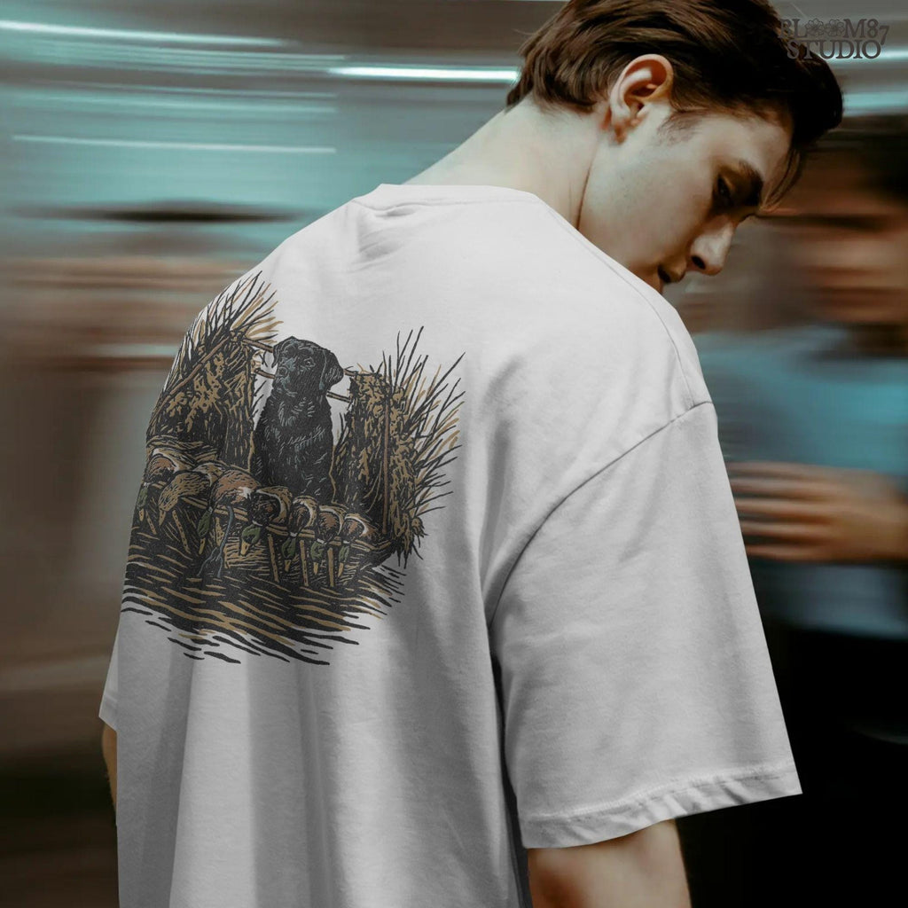 Black hunting retriever dog sitting in a duck blind with harvested mallards, rustic waterfowl hunting sublimation PNG design.