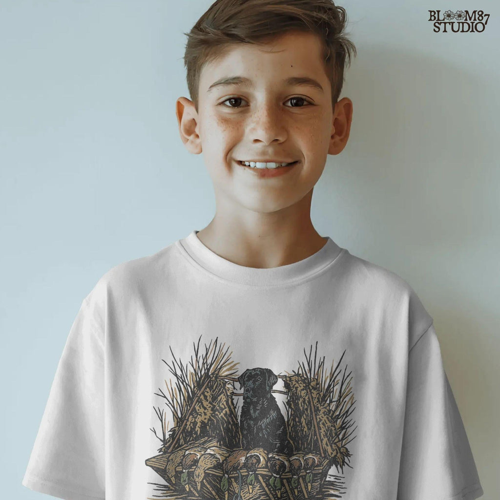 Black hunting retriever dog sitting in a duck blind with harvested mallards, rustic waterfowl hunting sublimation PNG design.