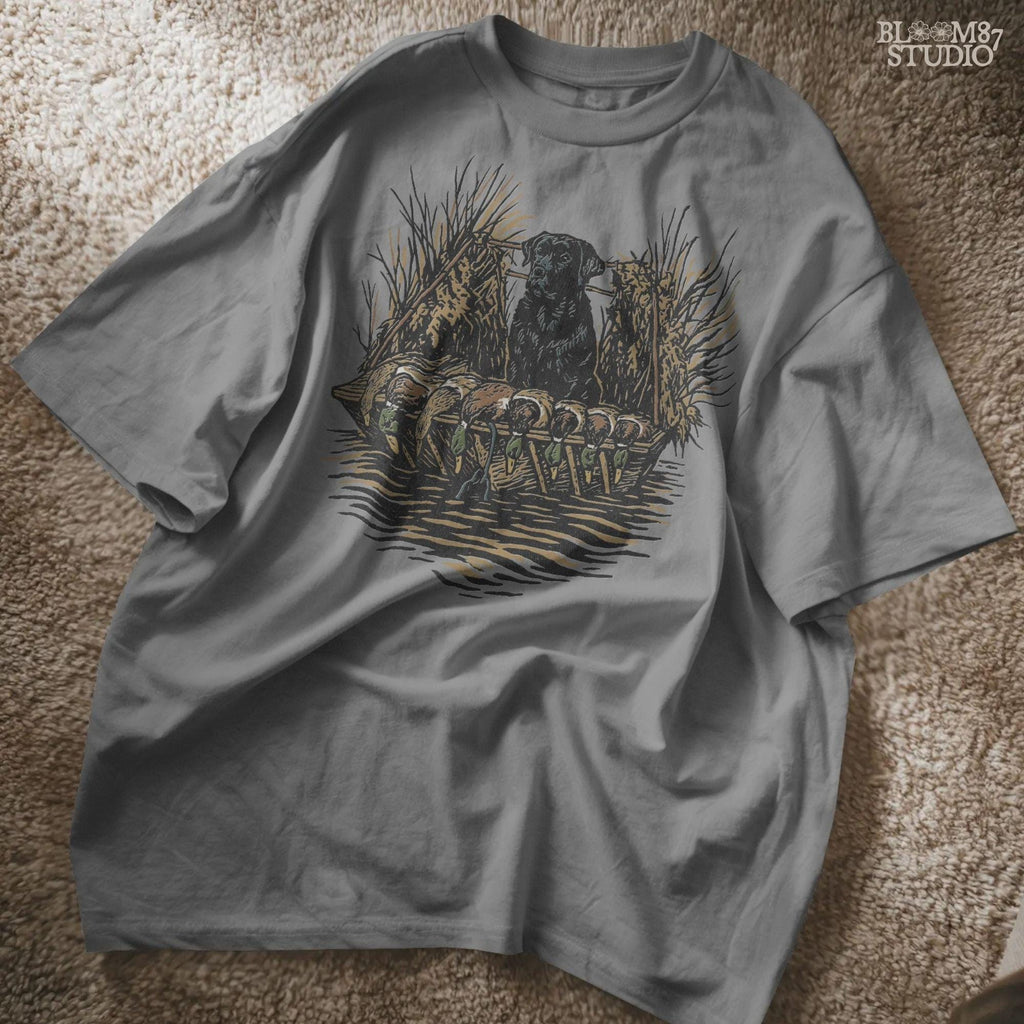 Black hunting retriever dog sitting in a duck blind with harvested mallards, rustic waterfowl hunting sublimation PNG design.