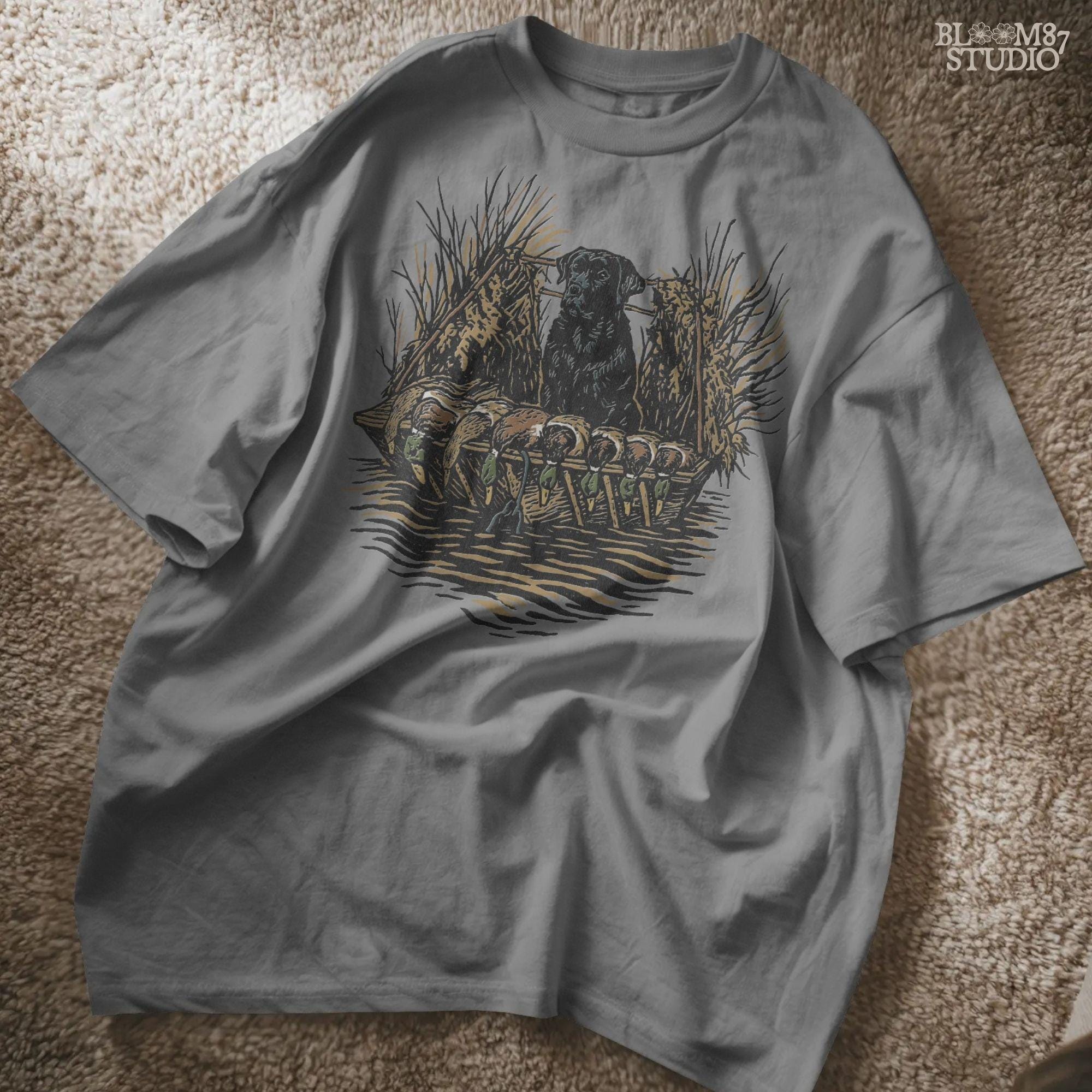 Black hunting retriever dog sitting in a duck blind with harvested mallards, rustic waterfowl hunting sublimation PNG design.