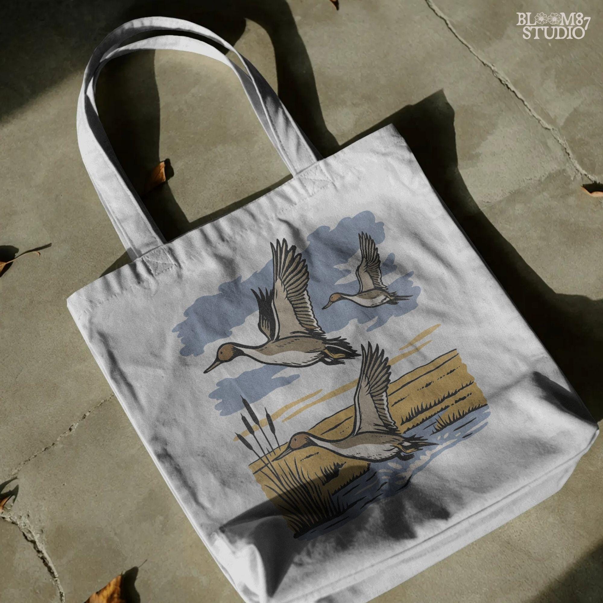 Rustic illustration of pintail ducks flying over wetlands, detailed waterfowl PNG for sublimation, hunting crafts, and wildlife decor.