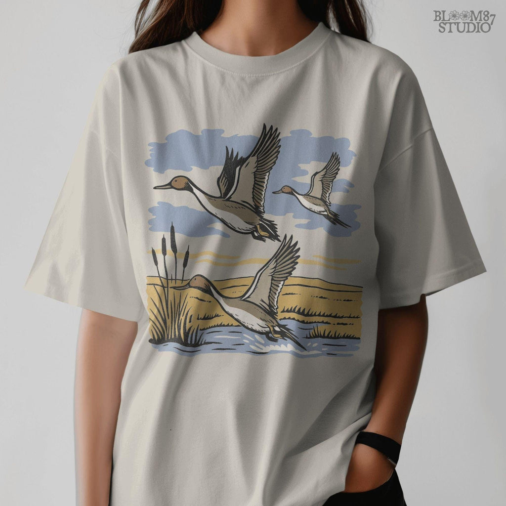 Rustic illustration of pintail ducks flying over wetlands, detailed waterfowl PNG for sublimation, hunting crafts, and wildlife decor.