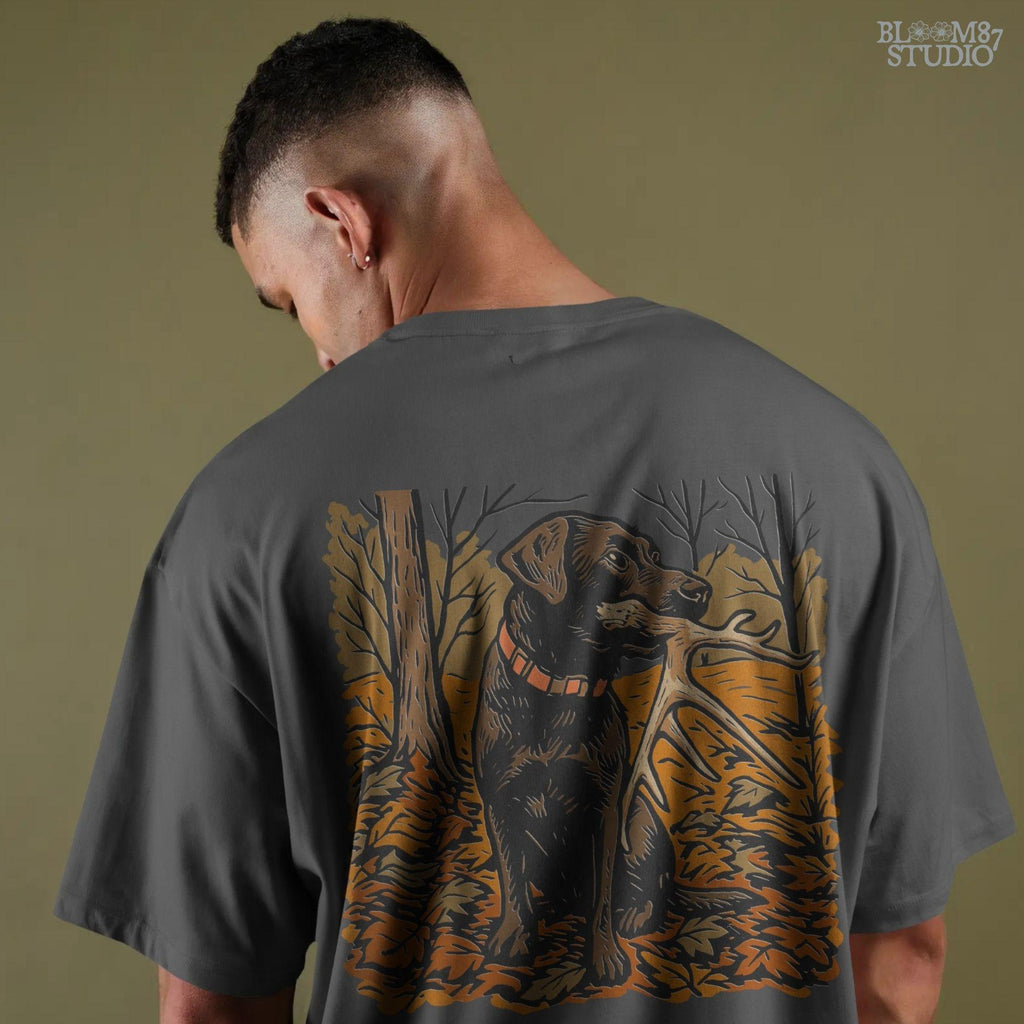 Illustration of a black Labrador dog sitting in autumn leaves holding a deer antler in its mouth, rustic hunting sublimation PNG design.