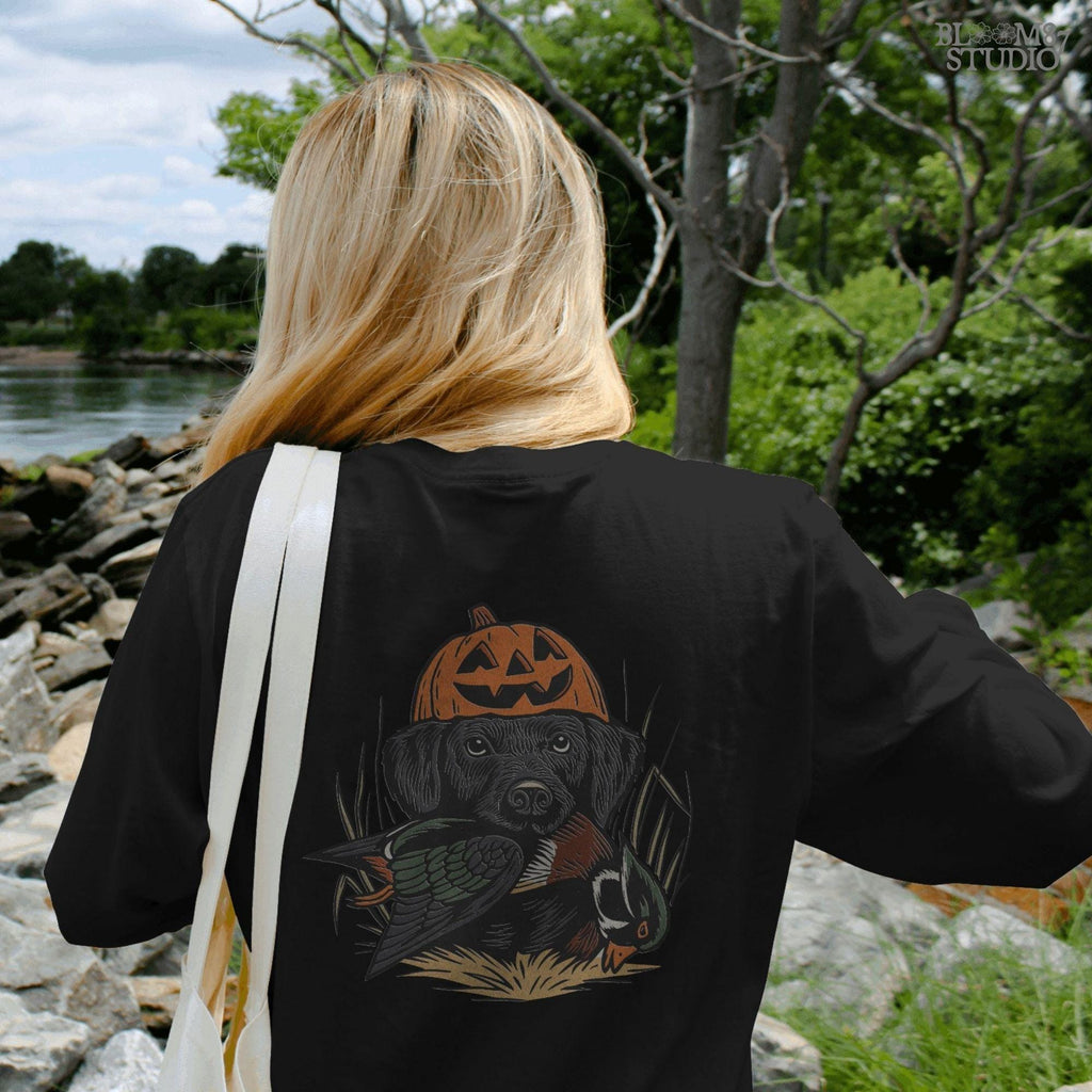 Solid version: "Black Labrador wearing pumpkin jack o lantern hat holding duck, Halloween hunting dog sublimation PNG solid style"

Distressed version: "Halloween hunting dog with pumpkin hat and duck, black lab sublimation PNG vintage distressed version"