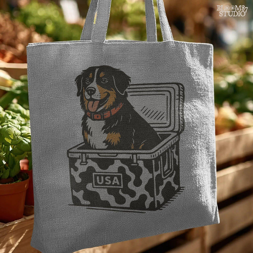 Bernese Mountain Dog sitting in a USA camo cooler, sublimation PNG design for hunting, camping, tailgate, and outdoor lifestyle projects.