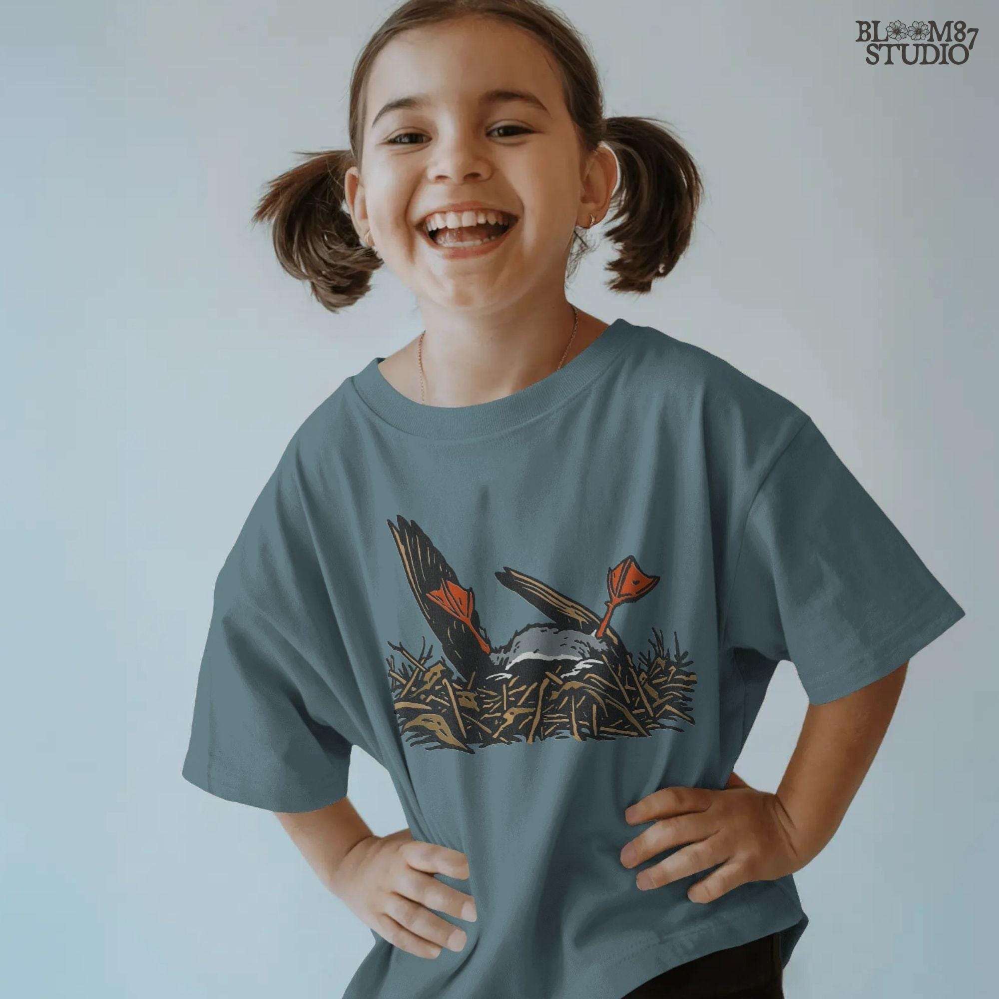 Solid Version:
Cartoon dead duck with orange feet lying in a nest, vintage style sublimation PNG for dark humor Halloween crafts.

Distressed Version:
Distressed-style dead duck illustration in a nest with exaggerated orange feet, ideal for rustic or spooky sublimation designs.