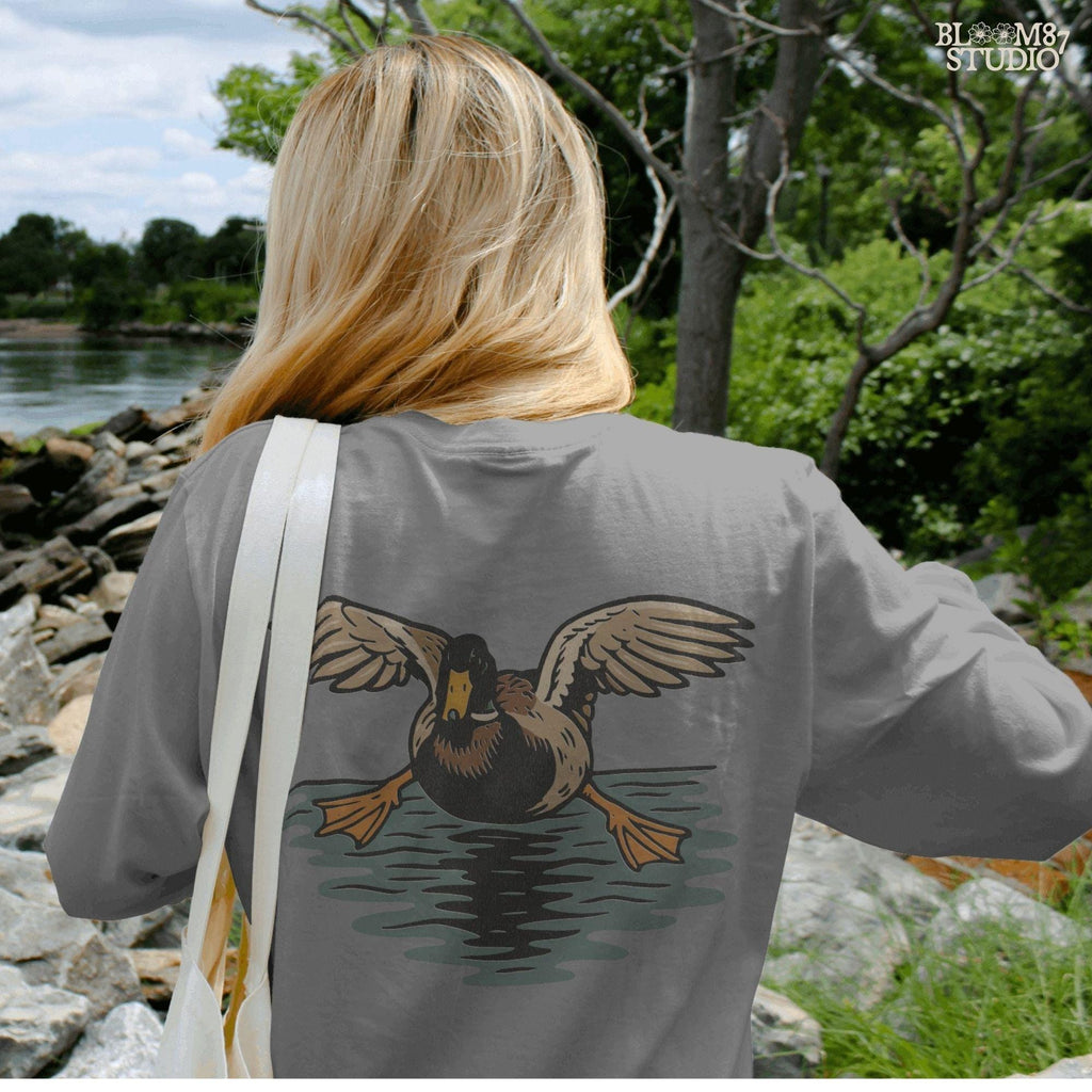 Solid Version:
Vintage-style sublimation of a duck landing on water with wings spread wide, great for rustic shirts or wildlife-themed crafts.

Distressed Version:
Distressed flying duck illustration landing on a pond, rustic clipart style ideal for outdoor nature designs and hunting-themed sublimation.