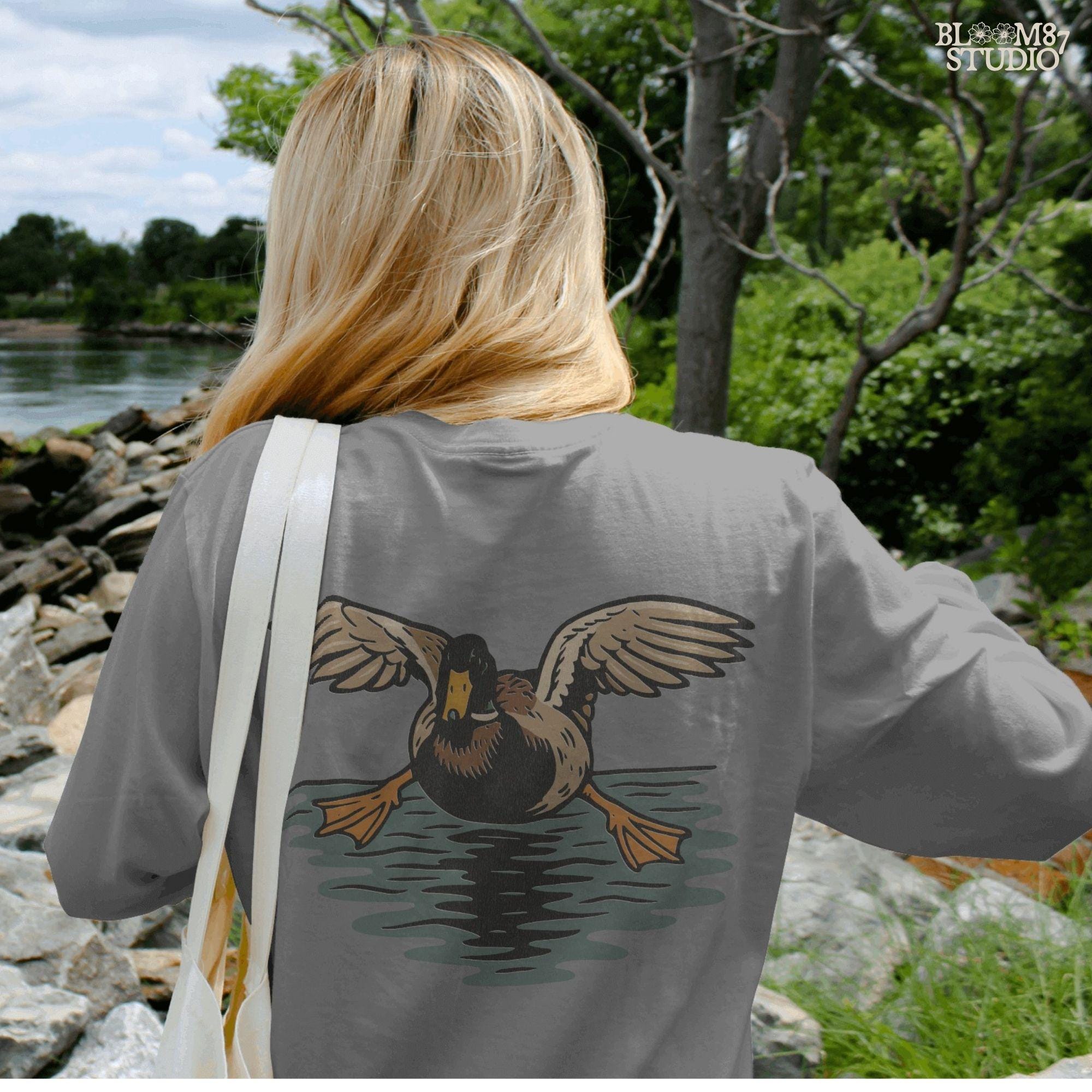 Solid Version:
Vintage-style sublimation of a duck landing on water with wings spread wide, great for rustic shirts or wildlife-themed crafts.

Distressed Version:
Distressed flying duck illustration landing on a pond, rustic clipart style ideal for outdoor nature designs and hunting-themed sublimation.